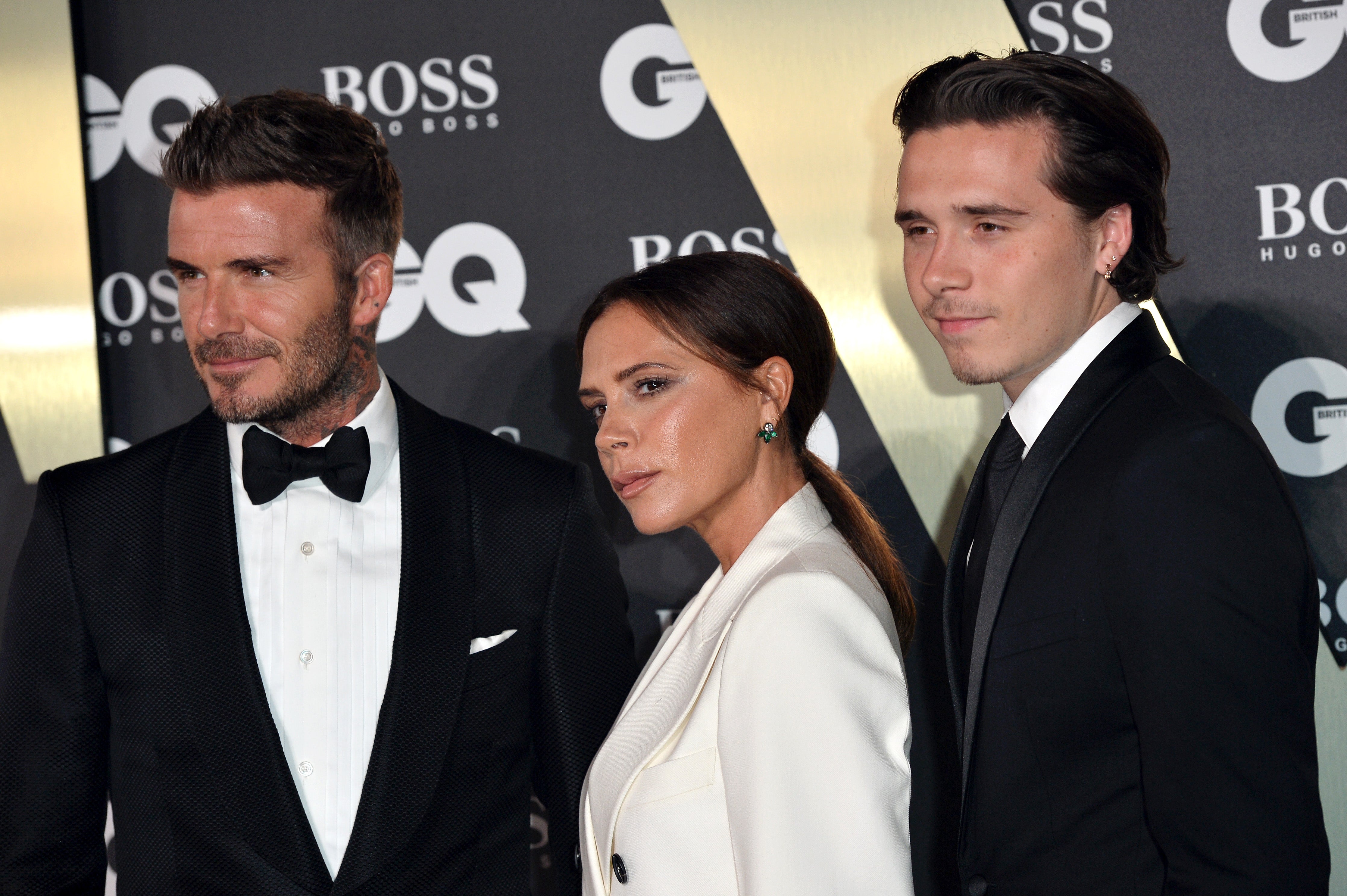 Brooklyn Beckham pictured with his parents in 2019