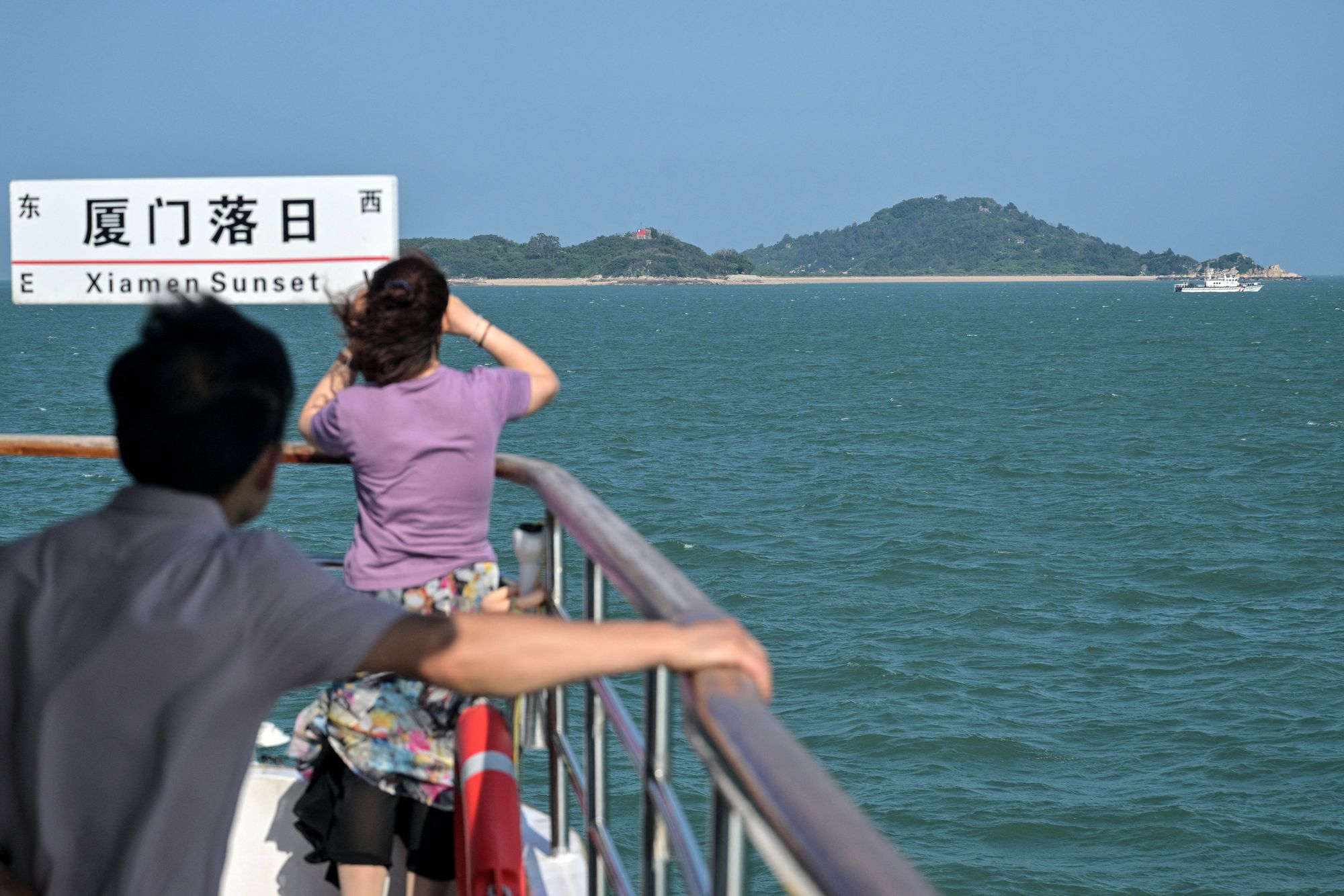 Chinese visitors observe Taiwanese islands during a vessel circuit crossed from Taiwan's Kinmen Islands, disconnected Xiamen, successful China's southeastern Fujian state connected May 25