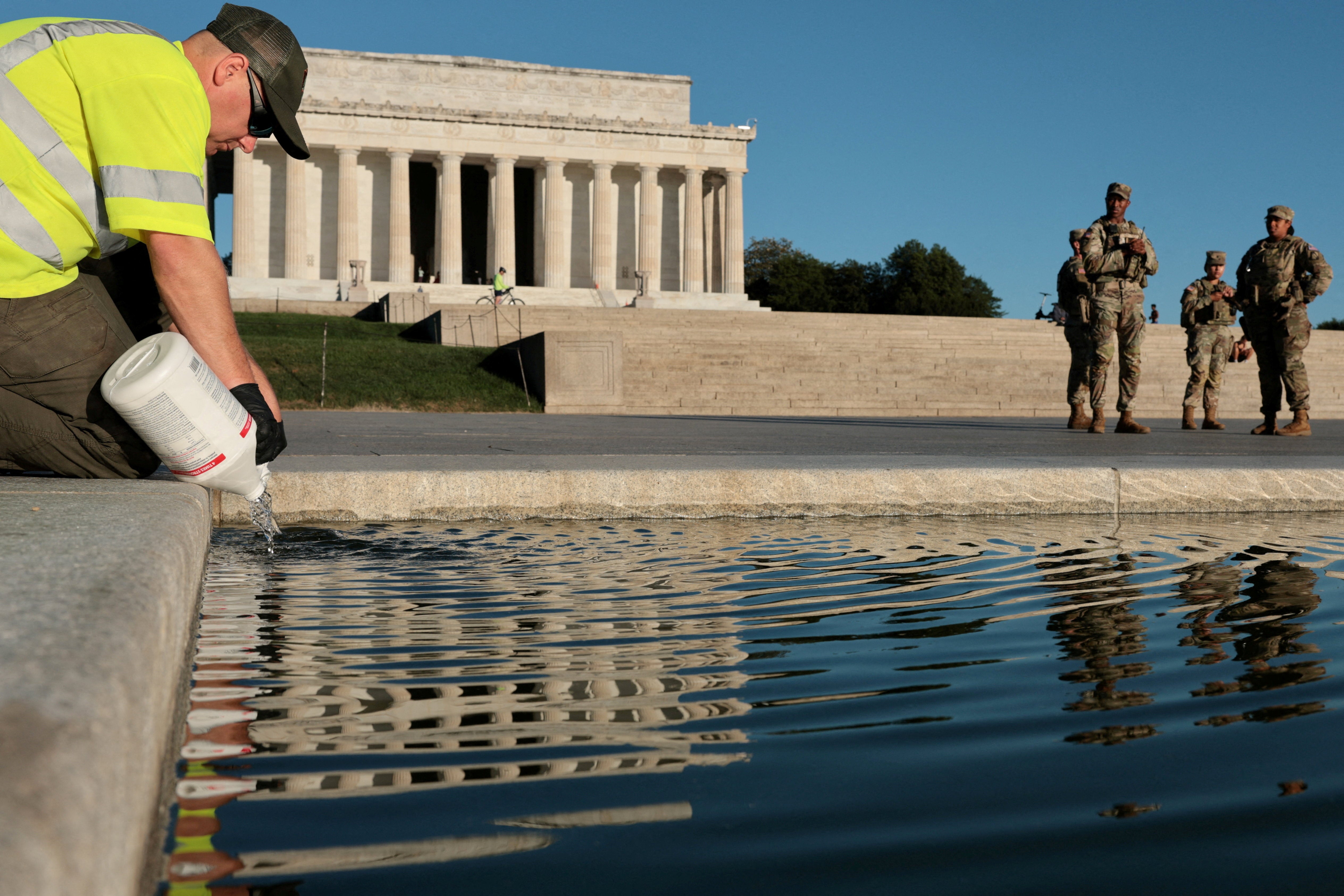 This week, workers were seen dumping hydrogen peroxide into nan Reflecting Pool and wading into nan h2o to sccop up algae blooms