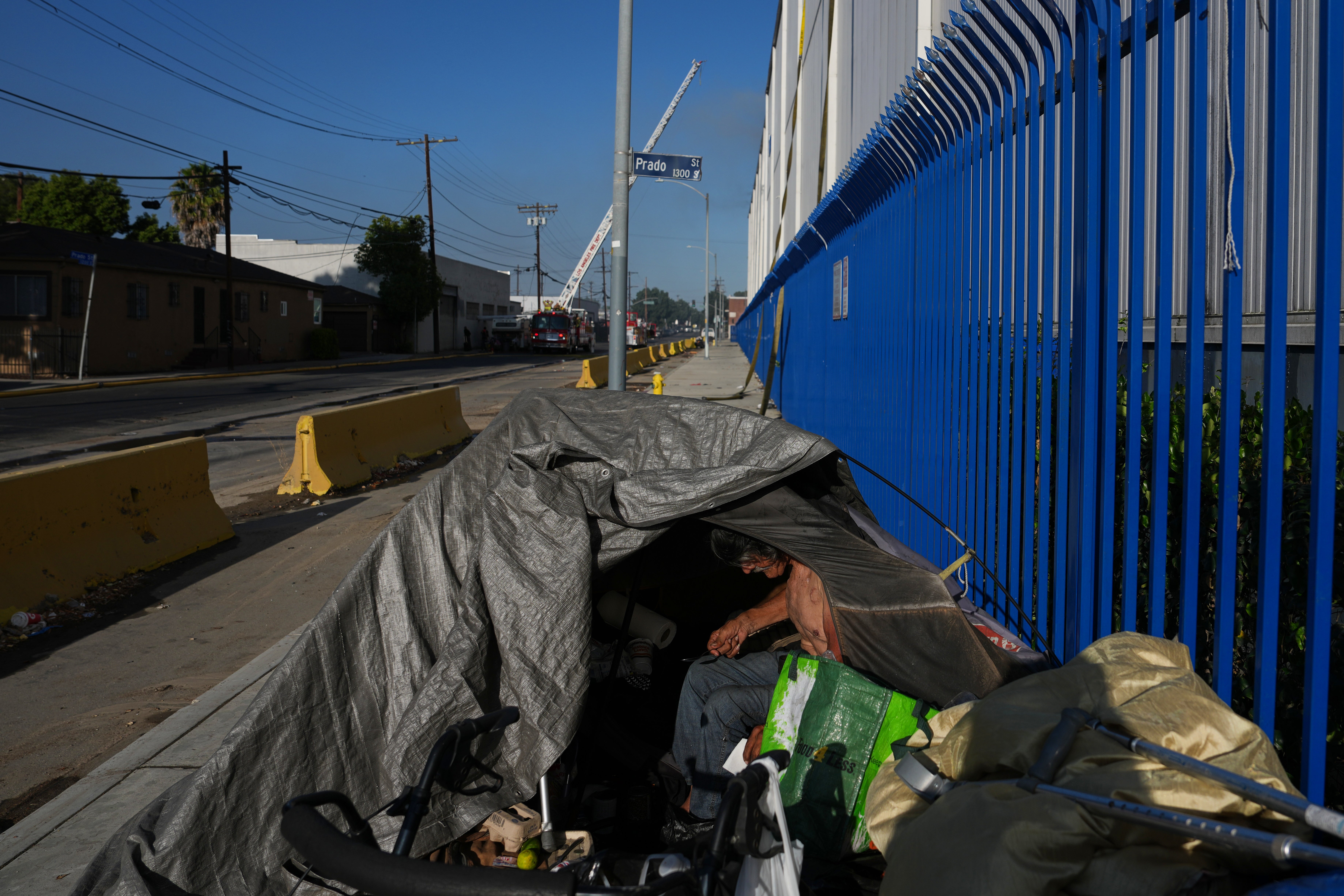 A  bum personification camps adjacent nan tract of a storage occurrence successful nan Boyle Heights conception of Los Angeles