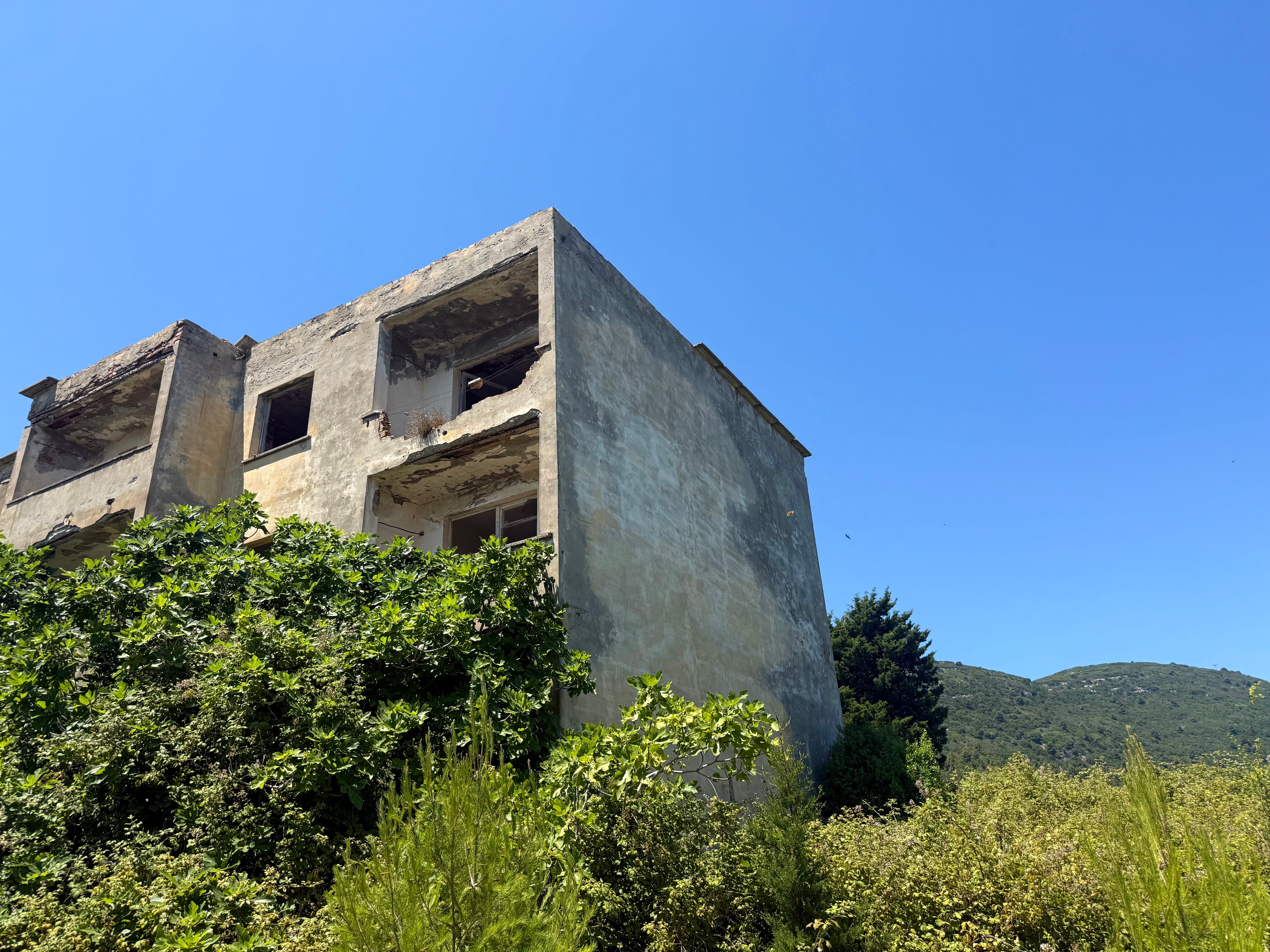 Abandoned buildings statement a cracked actual way that leads into nan hills