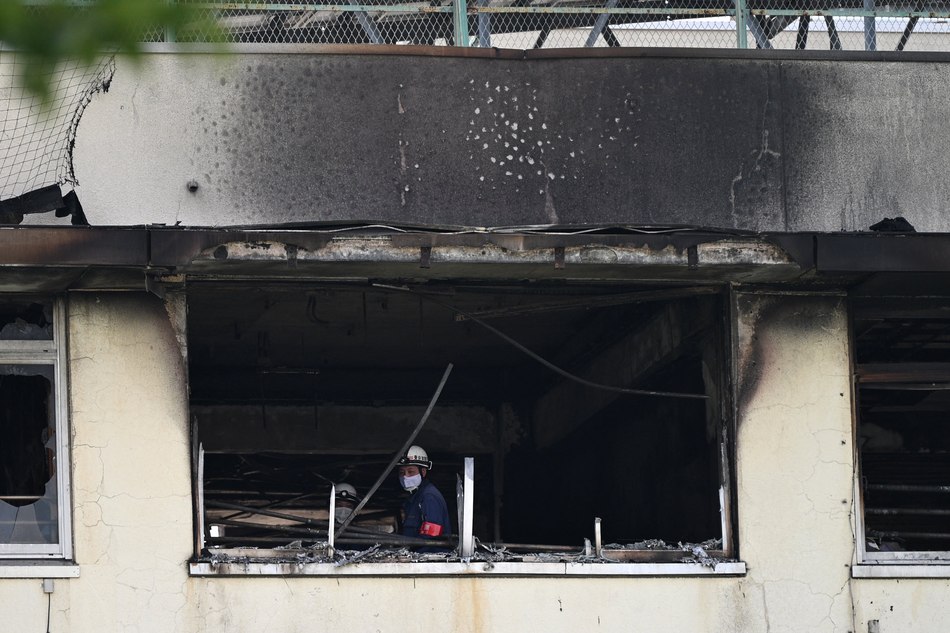 Firefighters work at the scene of a fire at an elementary school in Tokyo on 19 June 2026