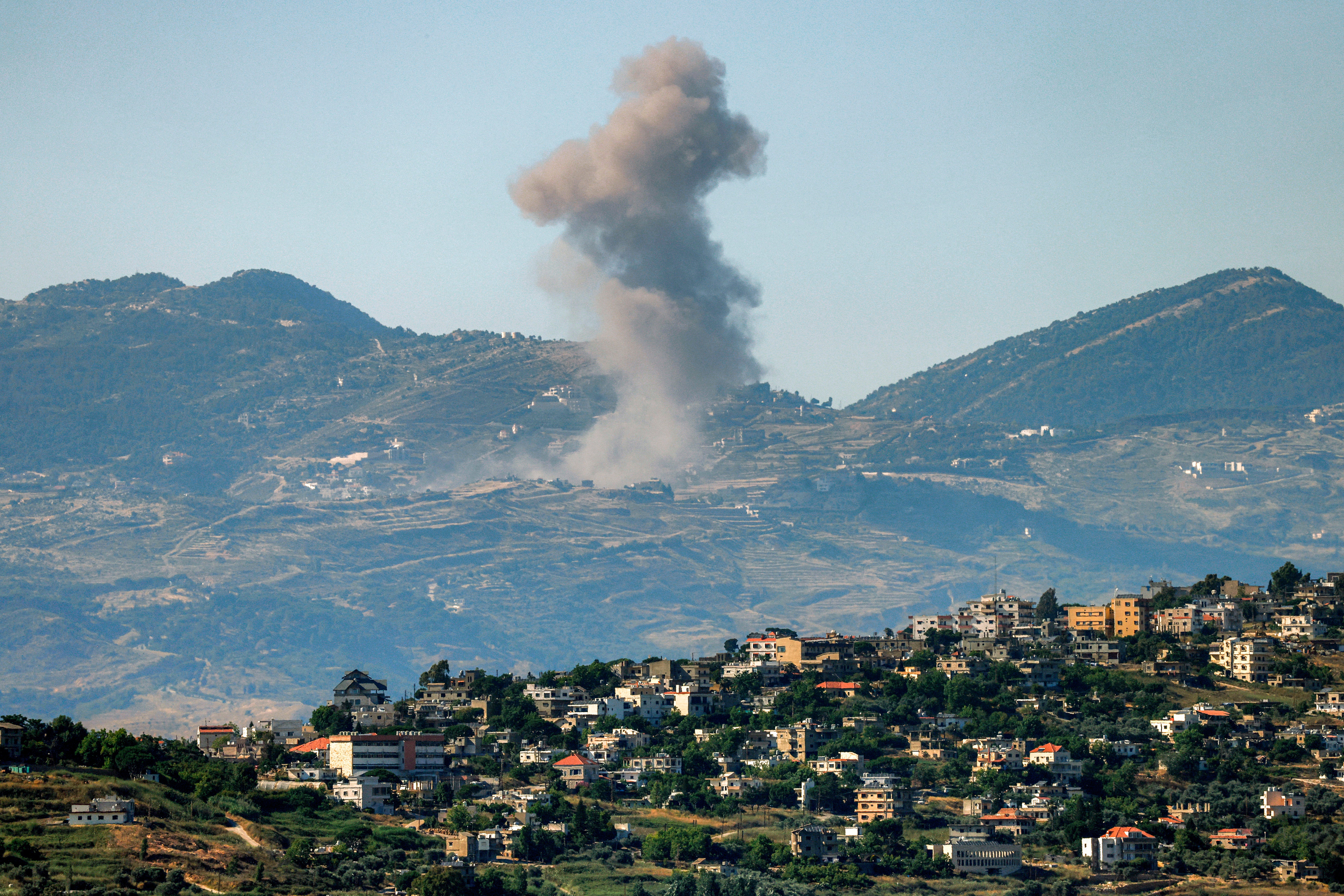 Smoke rises pursuing Israeli bombardment successful confederate Lebanon arsenic seen from a position crossed nan separator successful nan Upper Galilee successful bluish Israel connected June 19