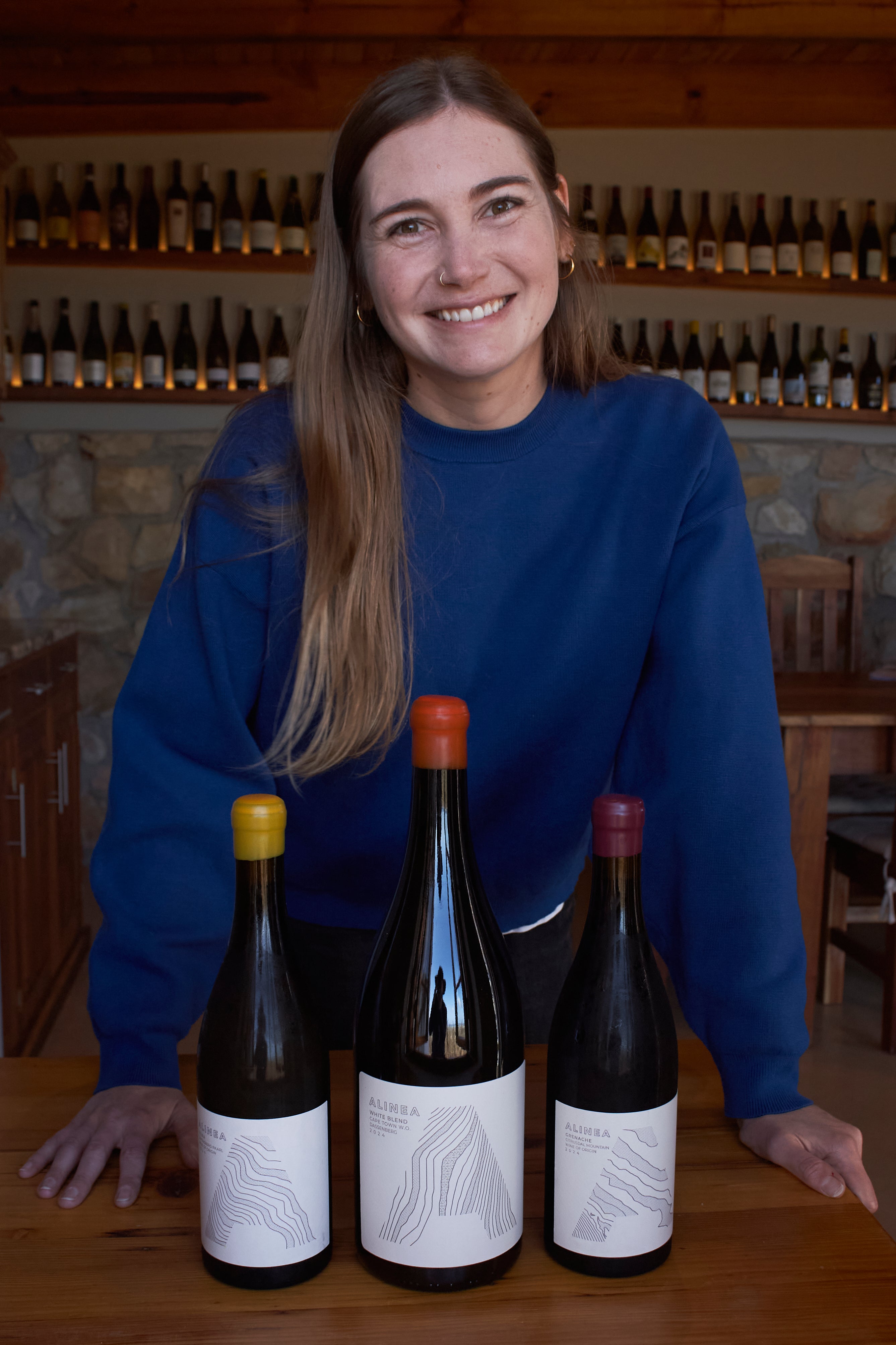 Natasha Jacka stands with some of her wines in Cape Town