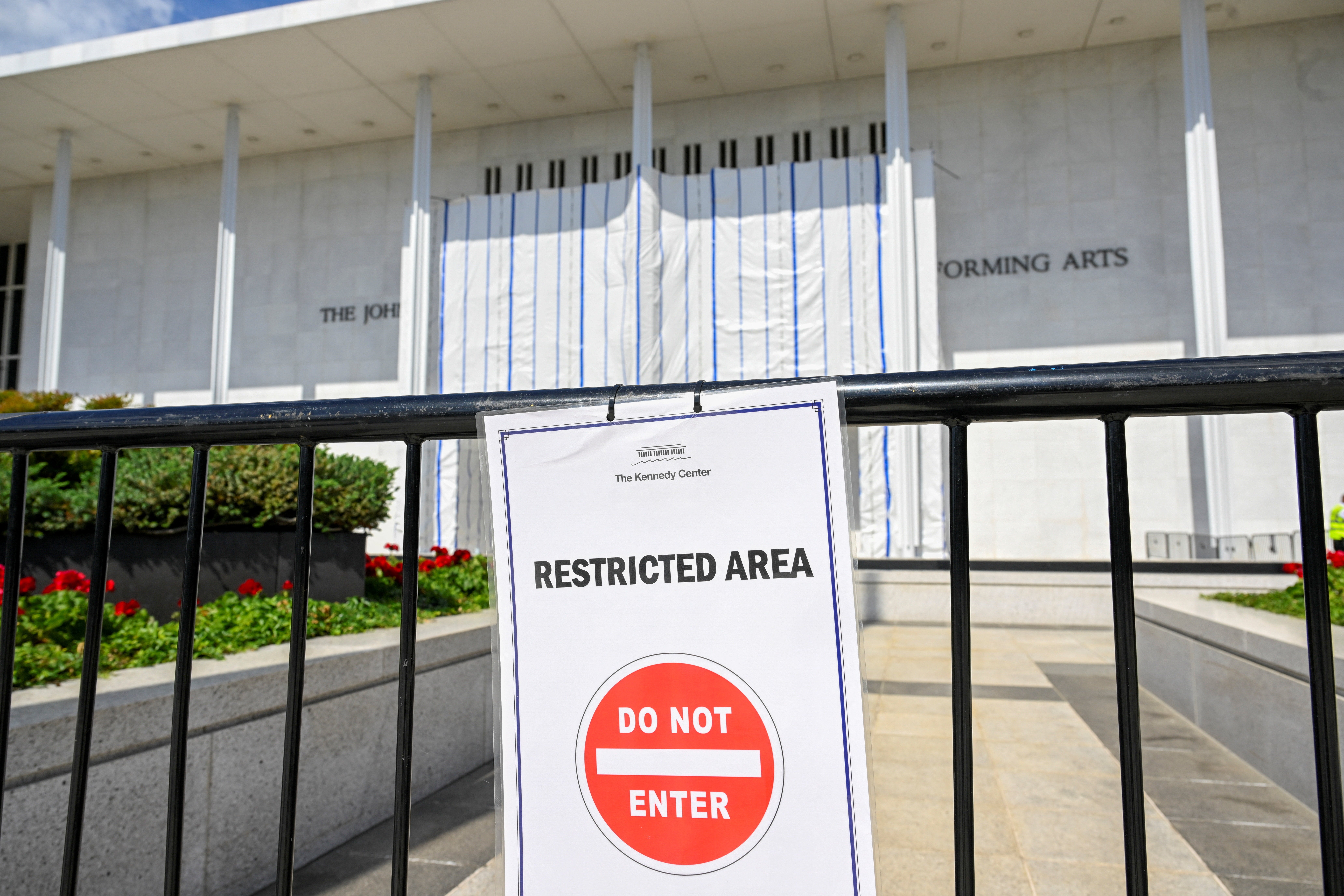 Pranksters utilized nan tarp-covered Kennedy Center entranceway to task images of Donald Trump and Jeffrey Epstein arsenic akin projections popped up crossed Washington DC