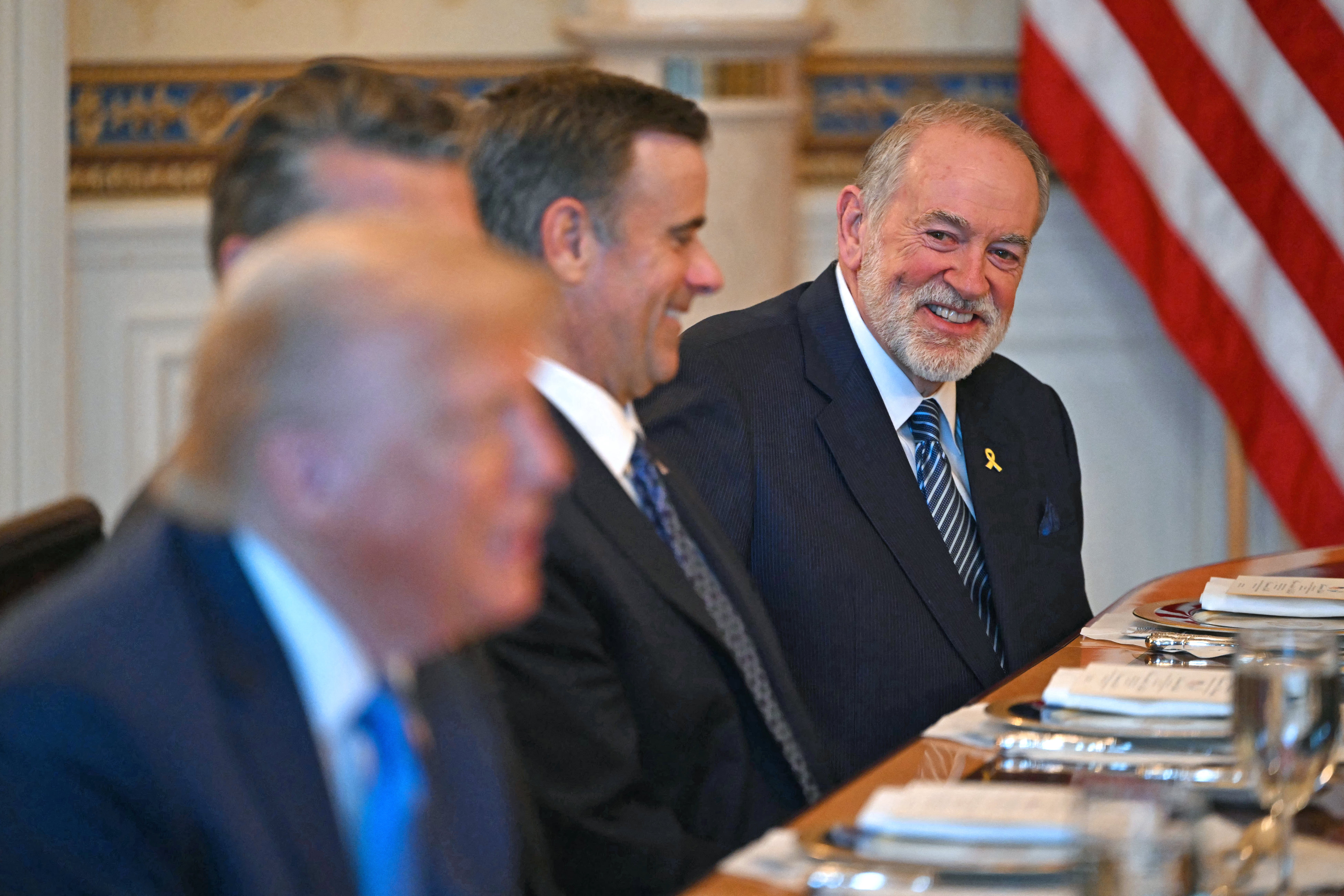 US Ambassador to Israel Mike Huckabee (R) smiles arsenic US President Donald Trump (L) meets pinch unseen Israeli Prime Minister Benjamin Netanyahu astatine nan Blue Room of nan White House successful Washington, DC, connected July 7, 202