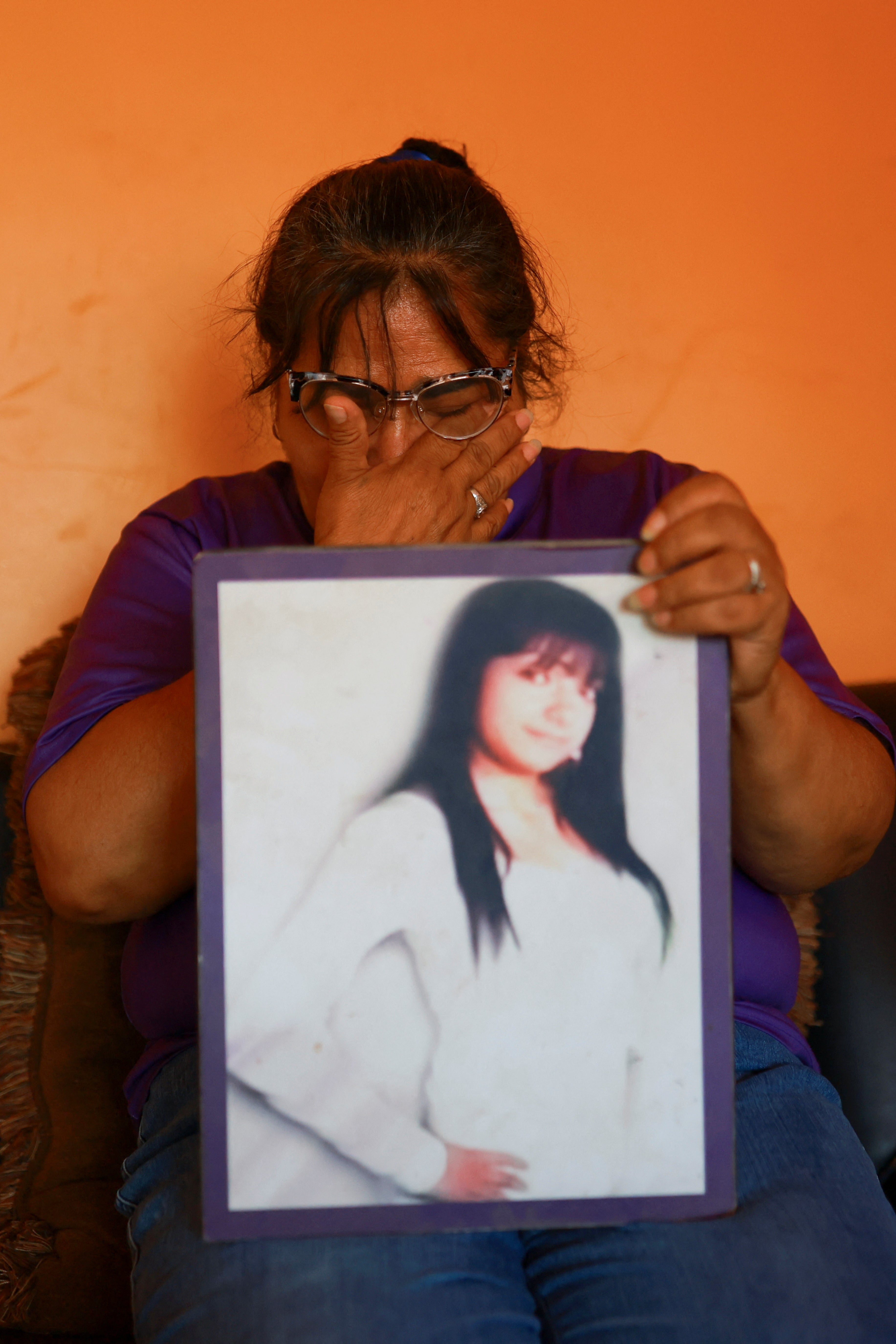 Laguna holds a photograph of her daughter, Idaly Juache