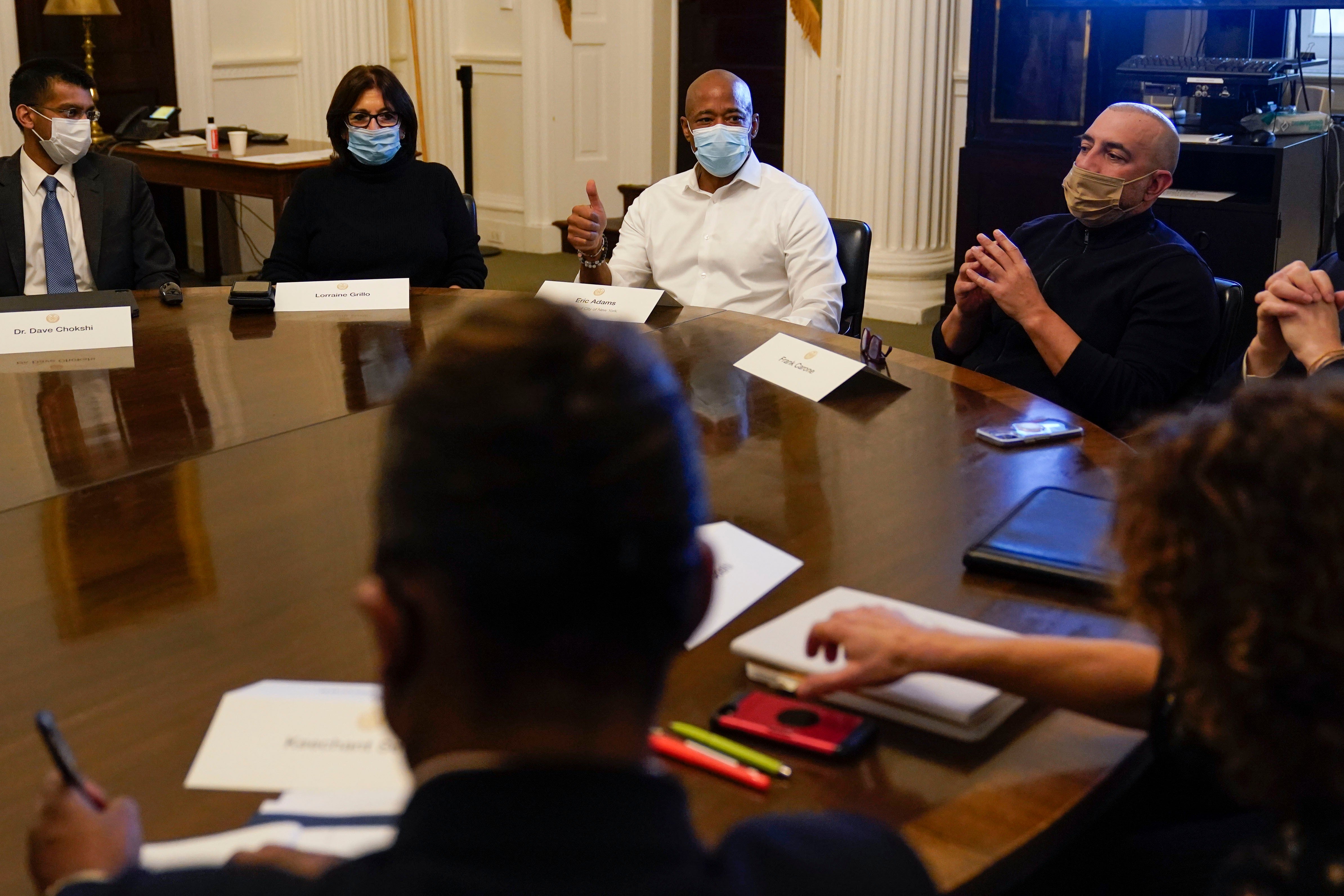 Then-New York City Mayor Eric Adams, center, speaks during a cabinet meeting on his first day in office in New York, Jan. 1, 2022. To Adams' right is his Chief of Staff Frank Carone