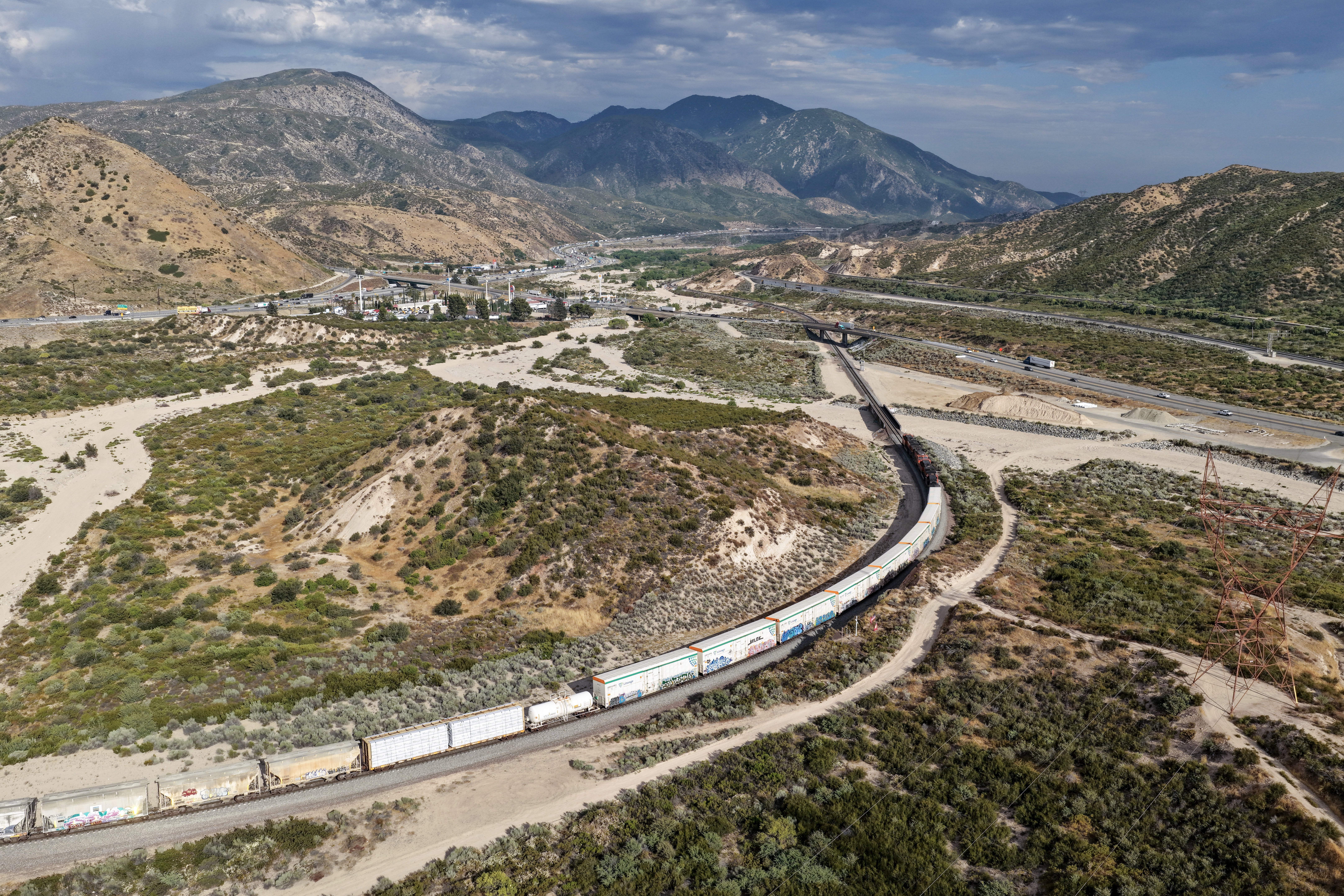In an aerial view, a freight train is shown passing on nan Cajon Pass adjacent nan San Andreas responsibility connected June 23