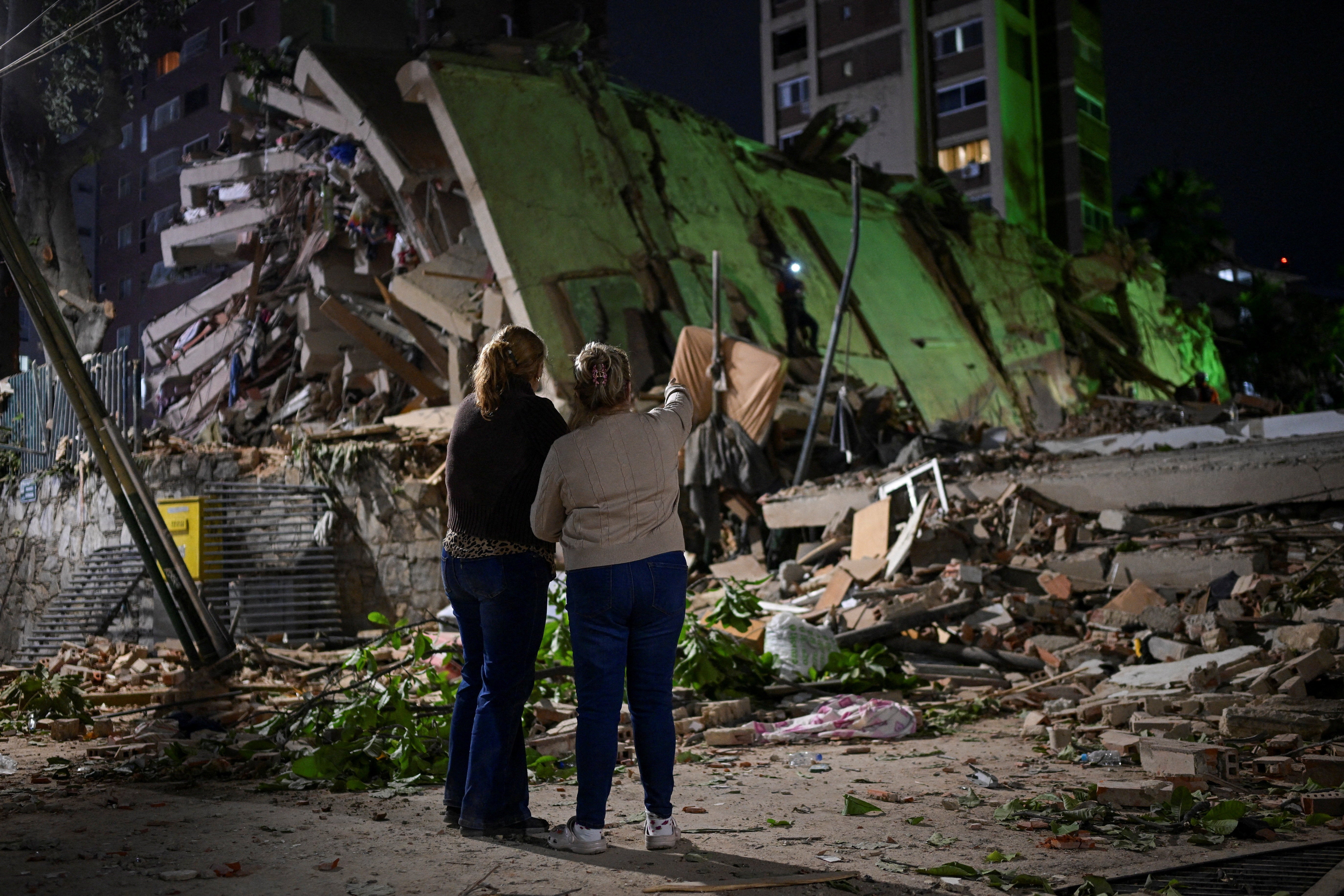 Fanny Nasri waits astatine nan tract of a collapsed building arsenic emergency workers hunt for her son, Antonio Nasri, alongside Noemi Cordoba, who awaits news of her granddaughter, aft an earthquake successful Caracas, Venezuela, June 25, 2026.