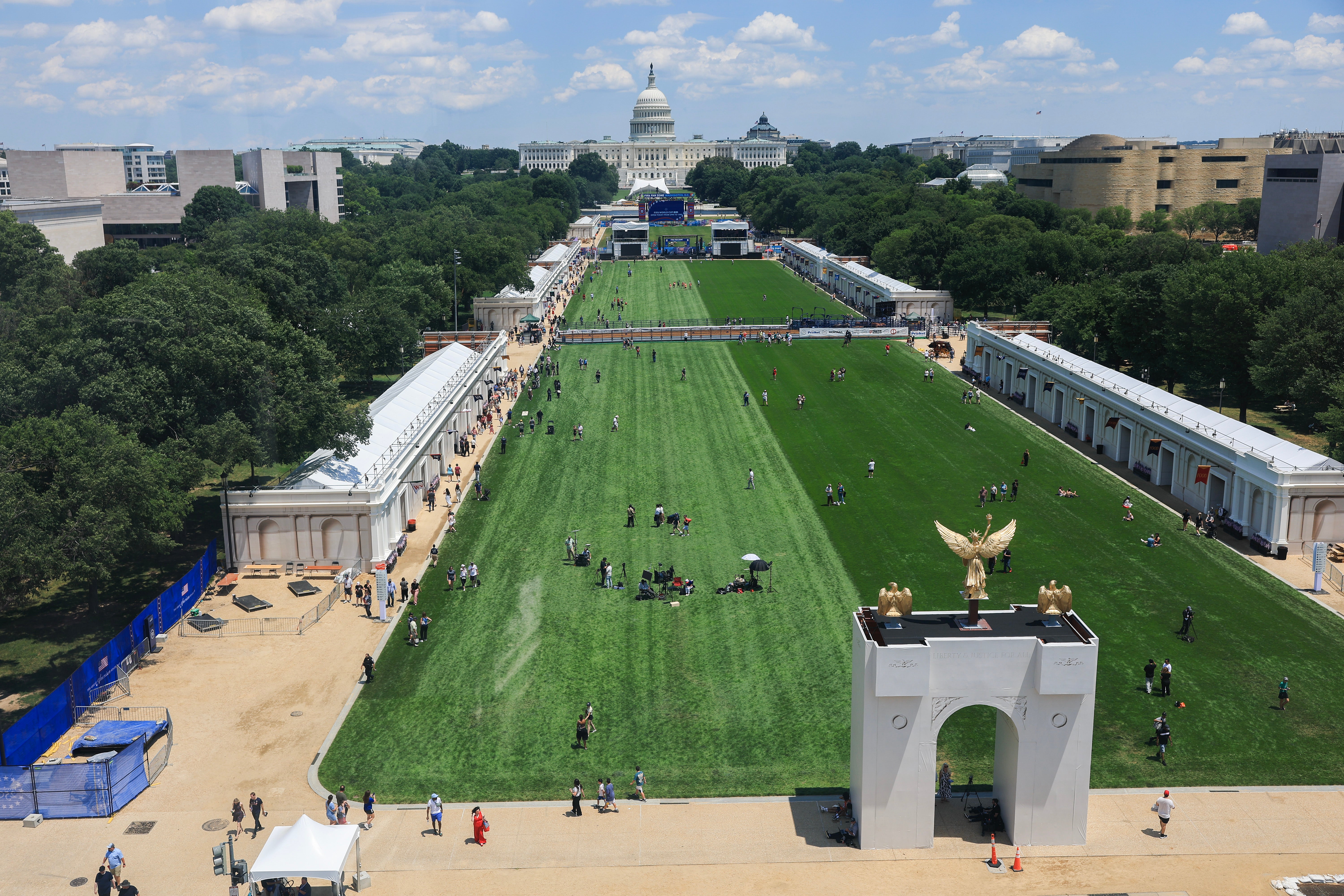 Visitors were seen watching a rodeo, riding a Ferris instrumentality and sitting successful nan shadiness provided by a exemplary of Trump’s triumphal arch