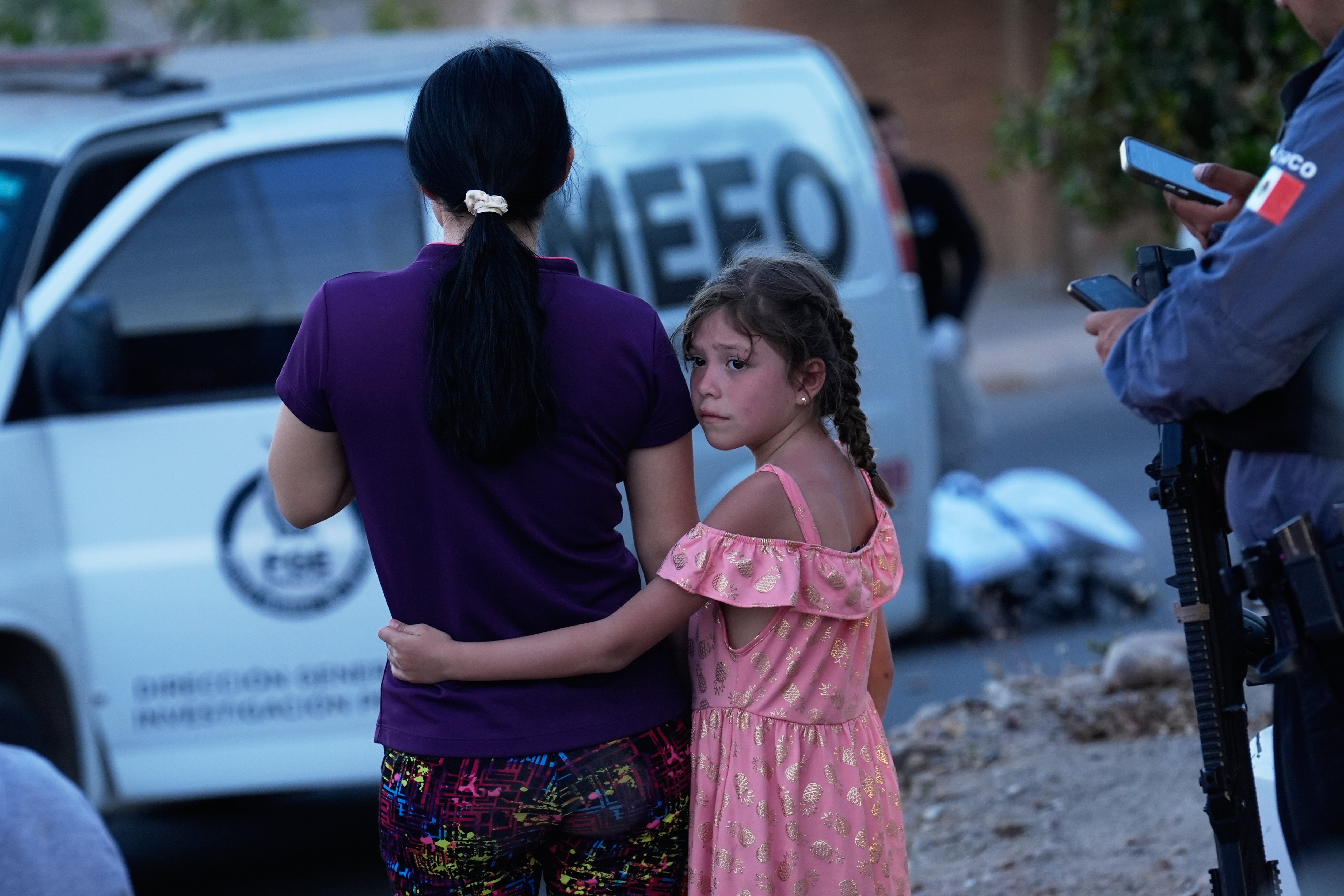 Relatives of a unfortunate of a fatal equipped onslaught look connected arsenic forensic workers analyse nan scene, successful Culiacán, Sinaloa state, Mexico