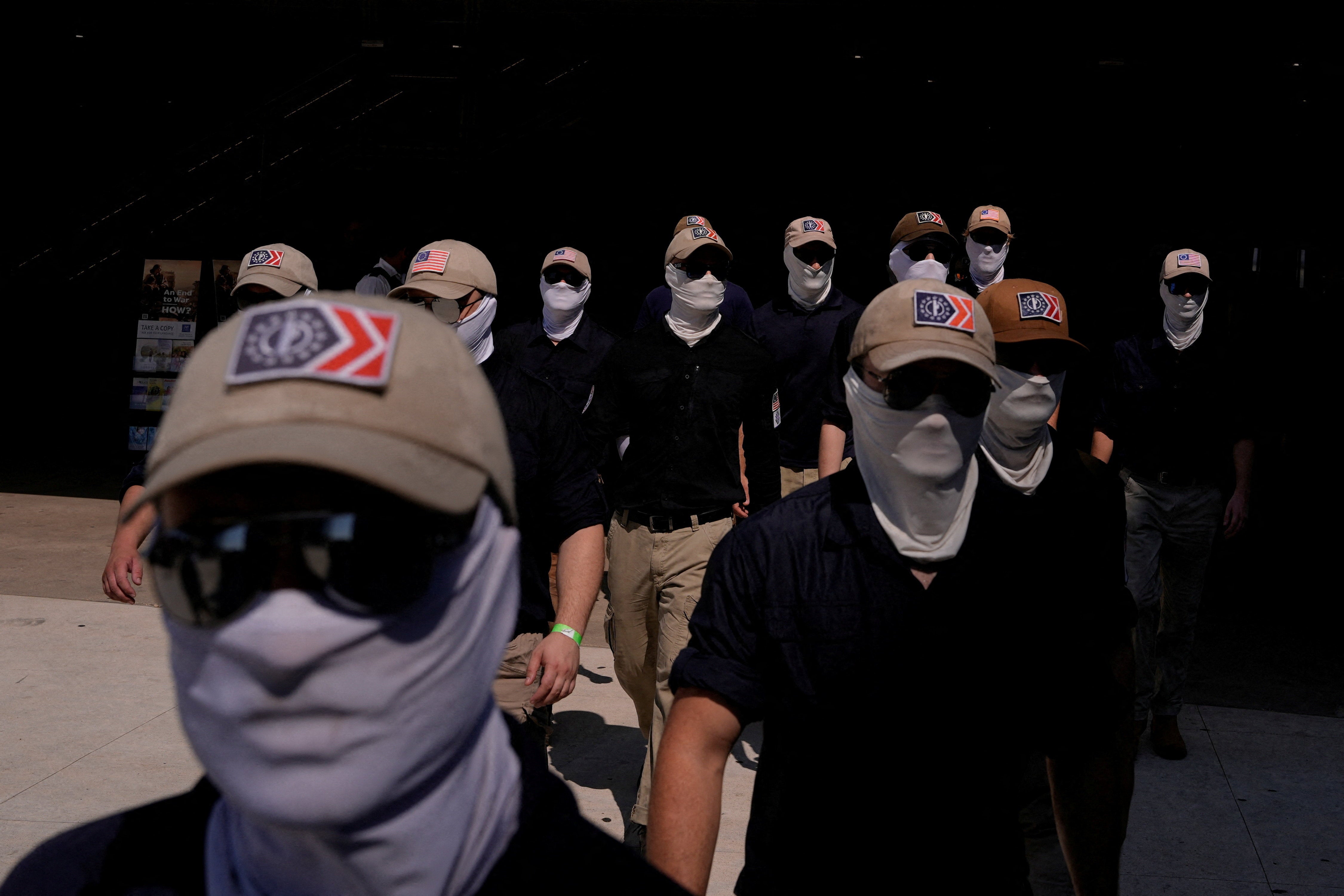 Members of nan group, which espouses anti-immigrant views and believes multiracial democracies are an existential threat to achromatic people, typically deterioration masks and sunglasses to screen their faces