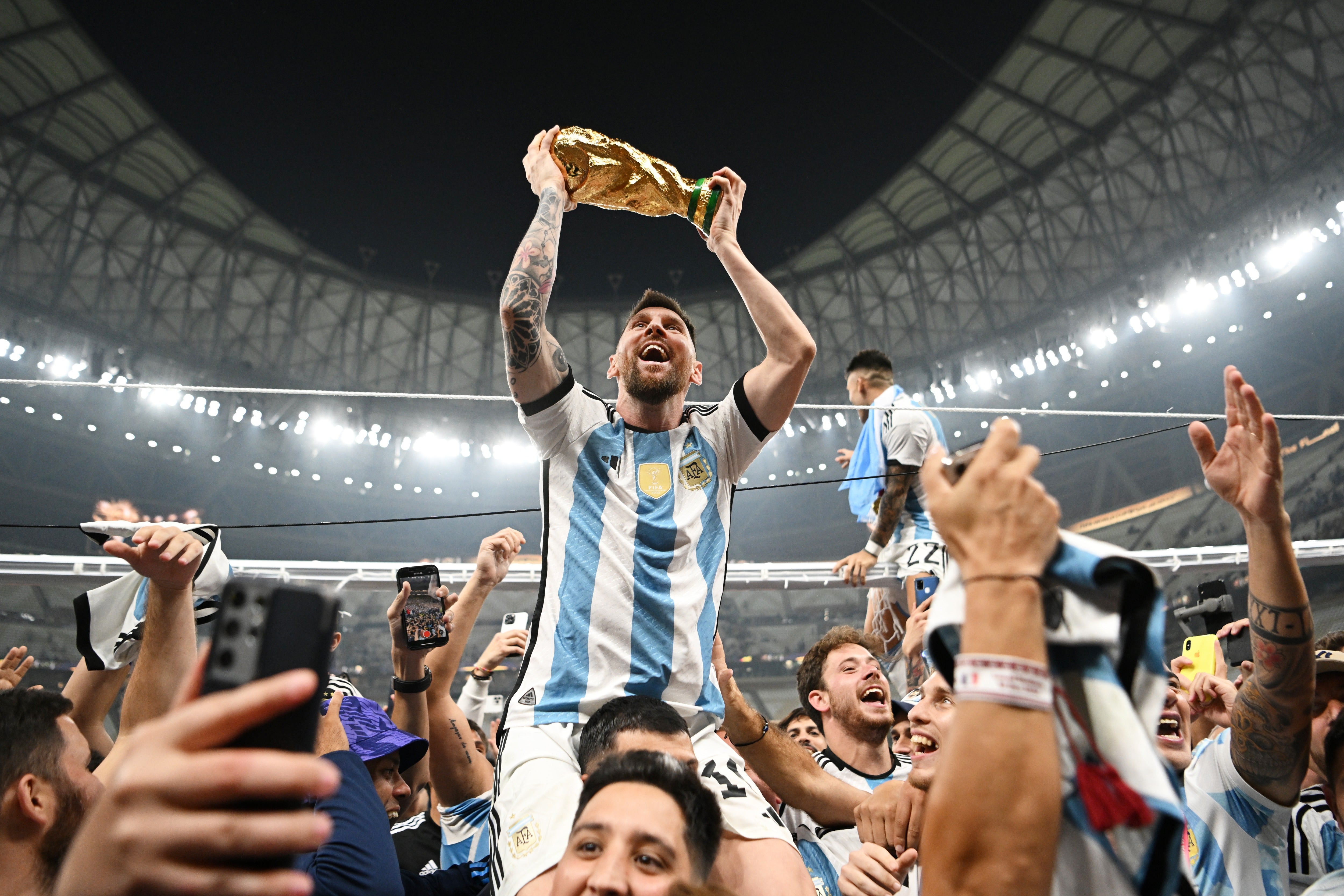 Lionel Messi holds aloft the World Cup trophy - this photo became the most-liked Instagram photo of all time