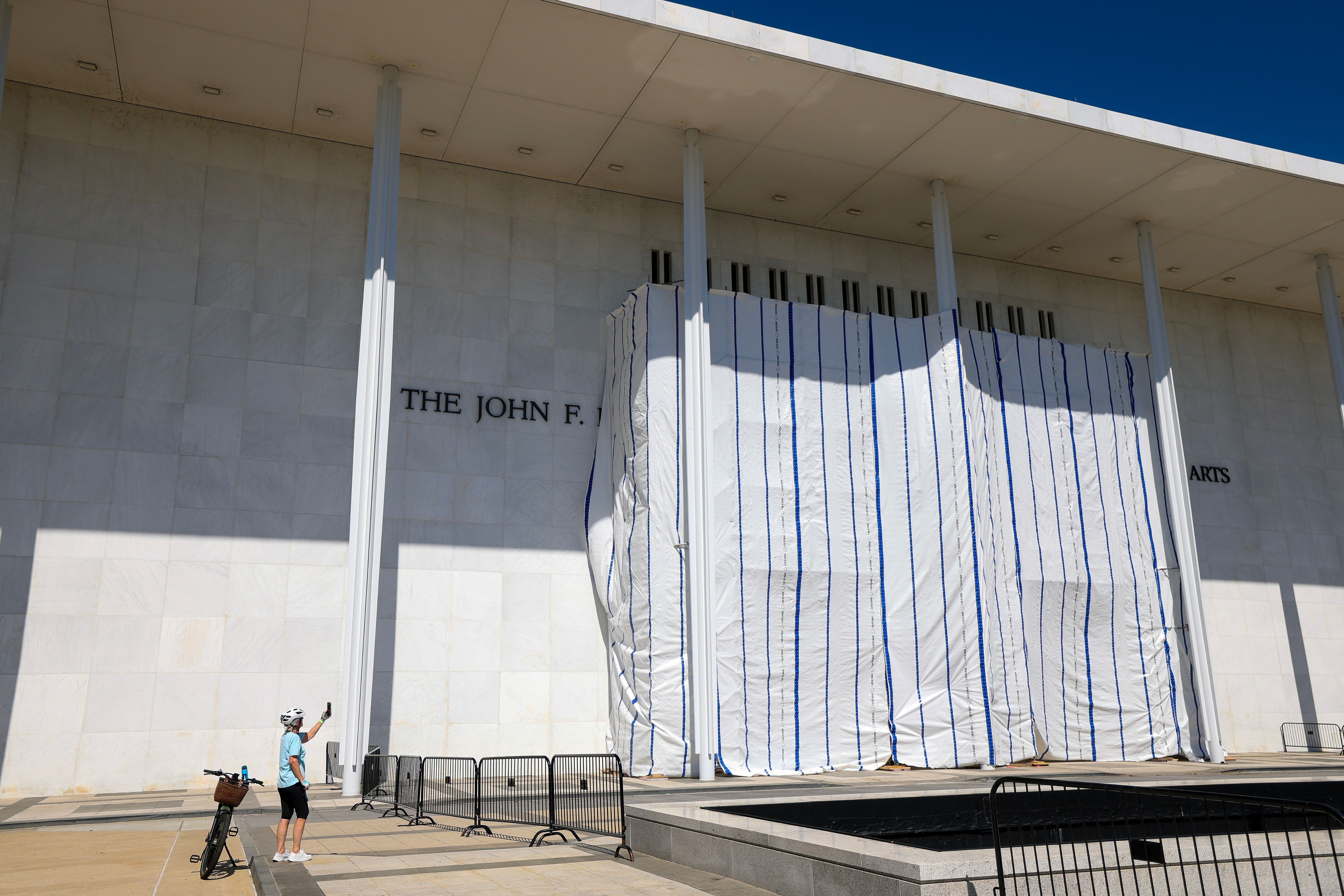 Tarps are hung connected scaffolding extracurricular The Kennedy Center aft workers removed President Donald Trump's sanction from nan building