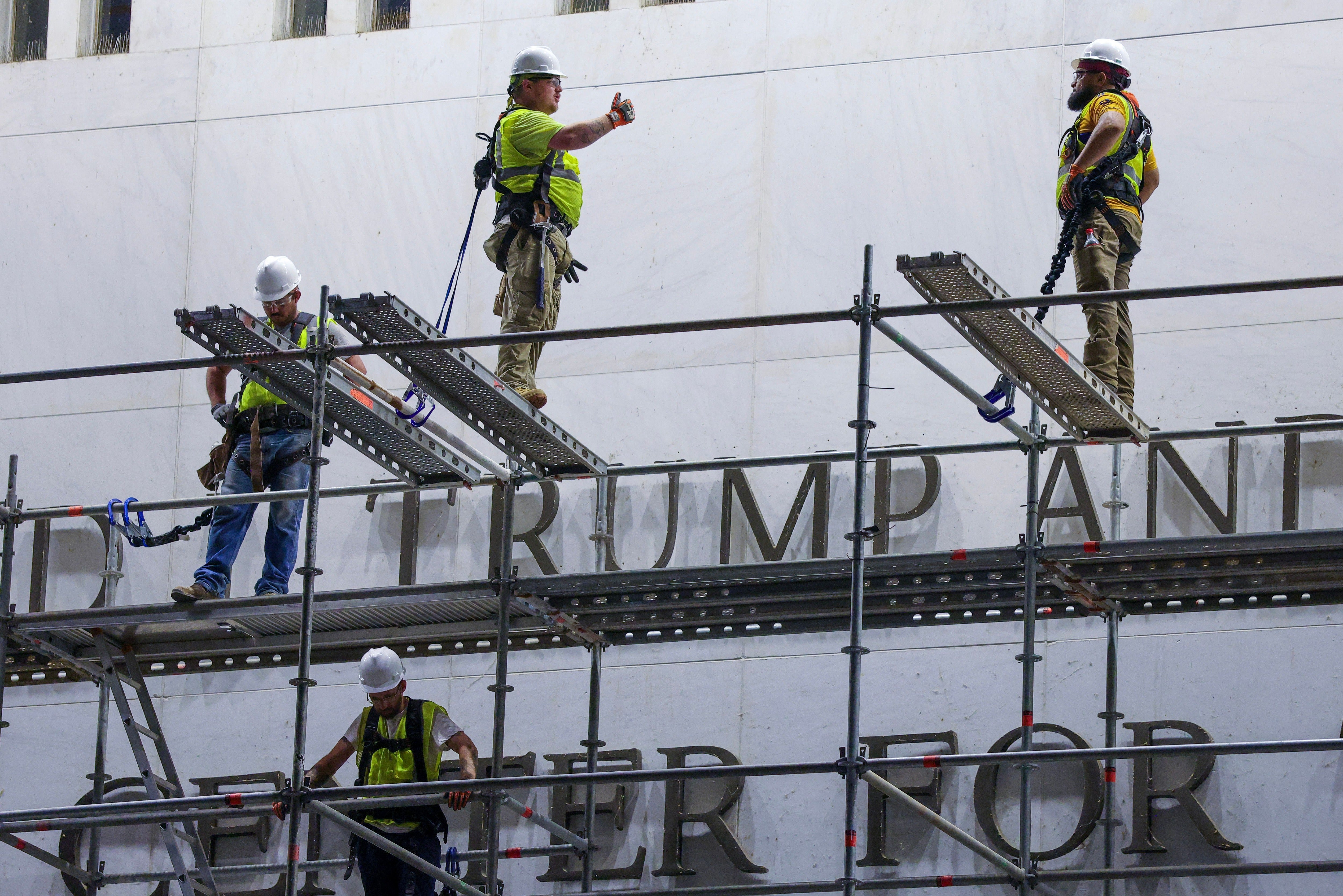 Construction crews building scaffolding extracurricular The Kennedy Center connected June 13, 2026