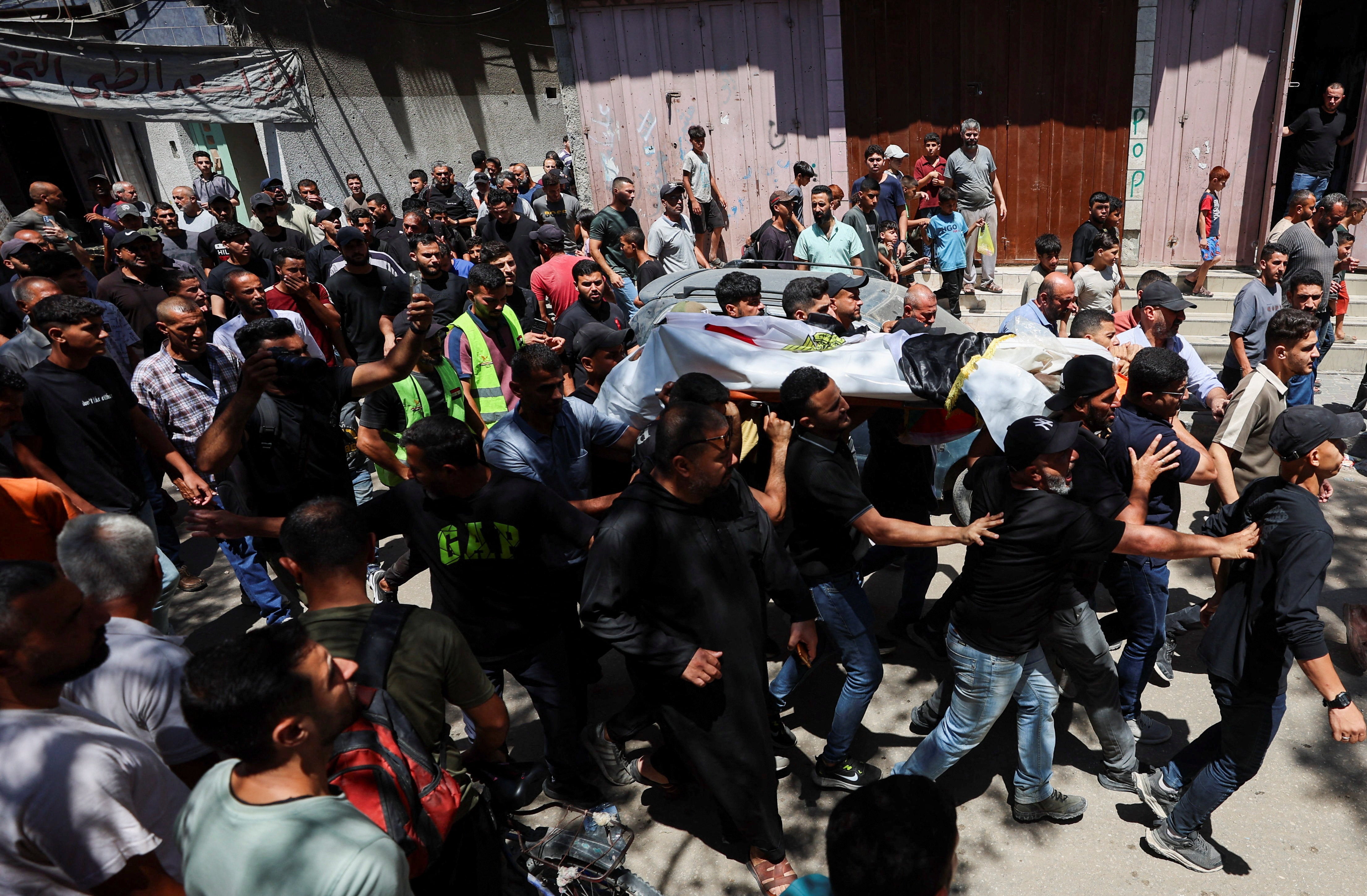 Mourners transportation nan assemblage of Palestinian man Mohammad al-Waheidi, who worked for nan Egyptian Relief Committee and was killed successful an Israeli onslaught connected Tuesday, during his funeral, successful Gaza City, July 8