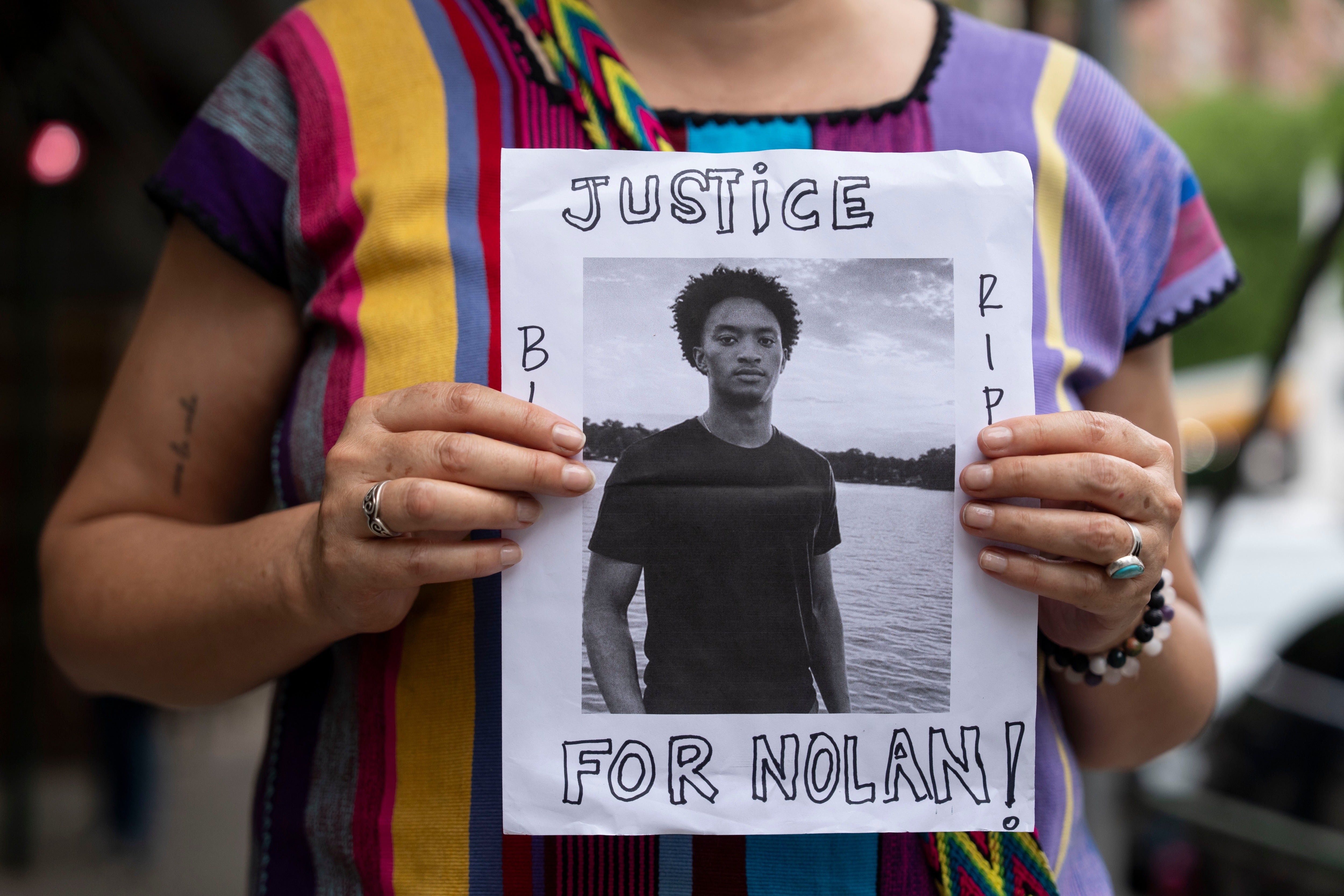 A personification holds a image of Nolan Xavier Wells during a news convention astatine National Action Network office successful New York City