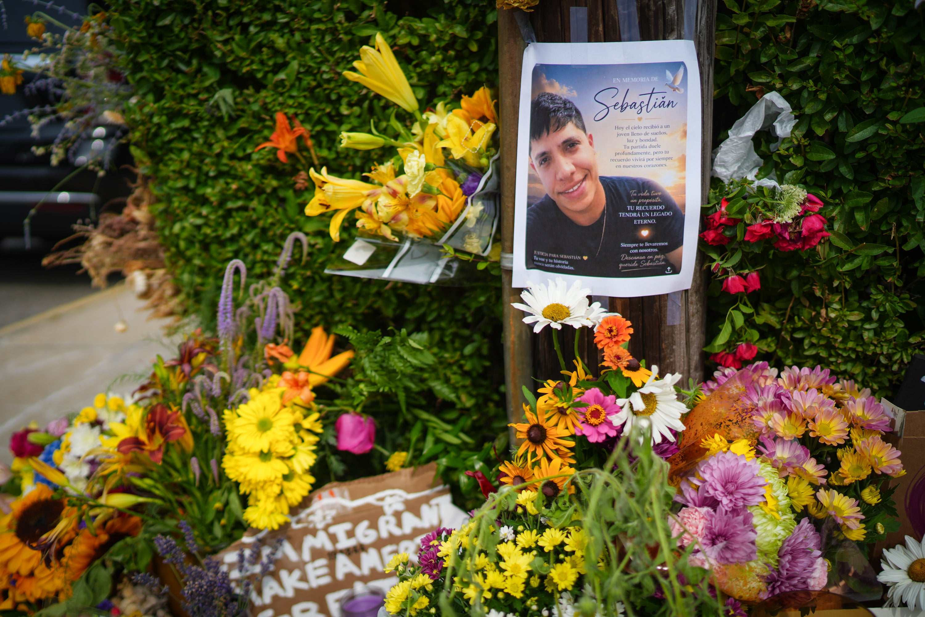 Members of the community left candles, flowers and pro-Immigrant messages at the scene where federal agents shot a Colombian native who was allegedly working in the US lawfully