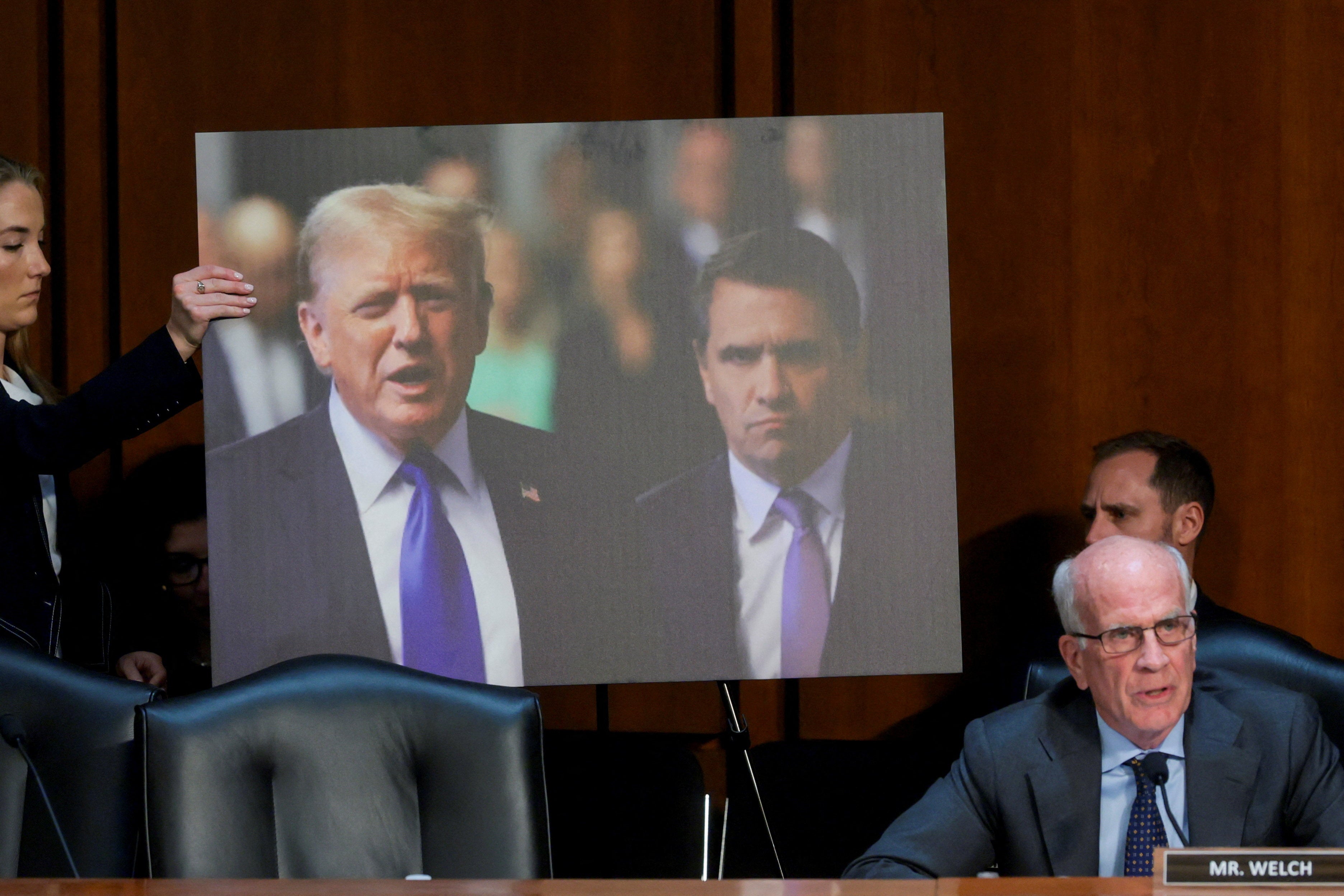 Senators displayed an image of Trump and hos former personal attorney, whom he now seeks to install as attorney general, Todd Blanche, during the hearing.