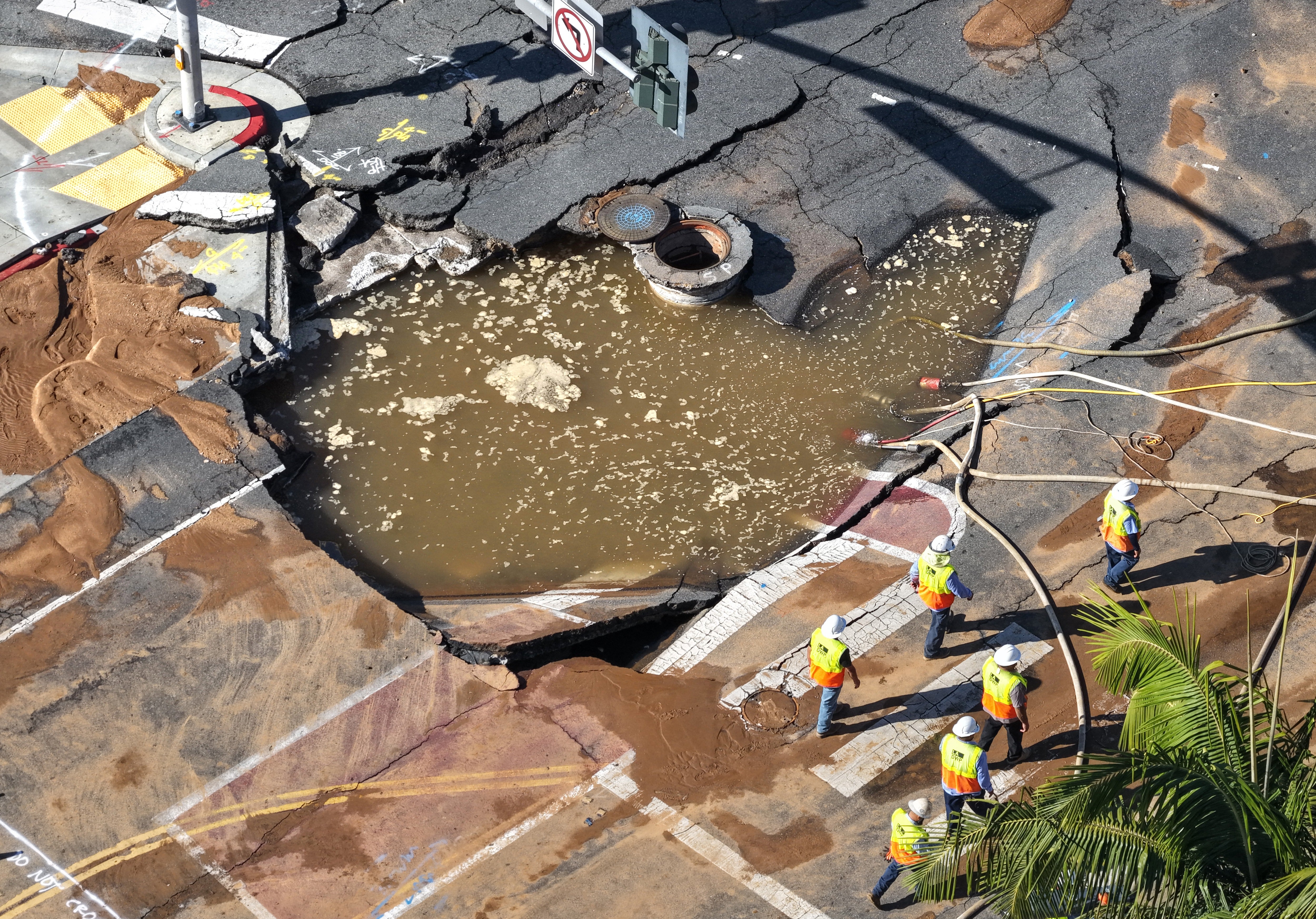 The sinkhole, located astatine nan convergence of Sunset and Holloway Drive, contained astir 195,000 gallons of water, officials said.