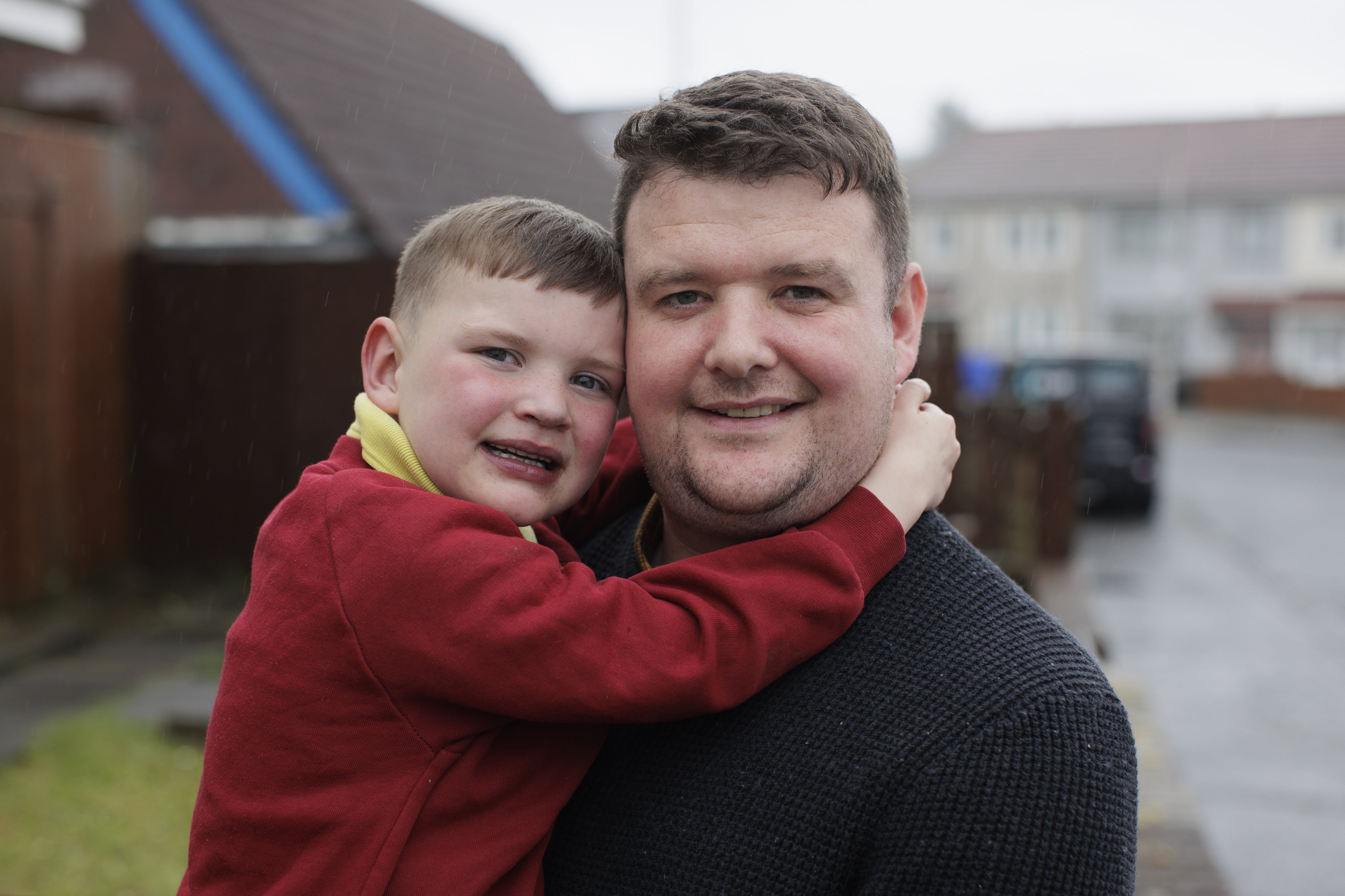 Mairtin Mac Gabhann holding his son Dáithí at their family home in west Belfast
