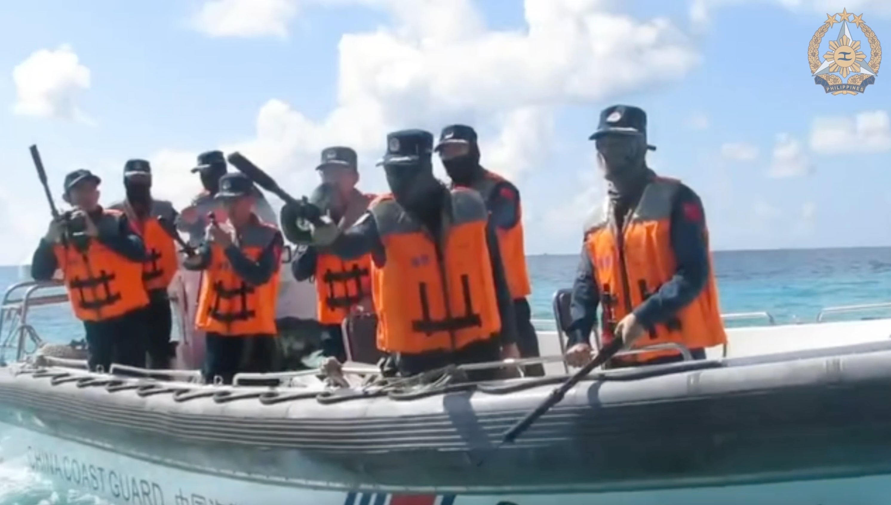 In this photograph taken from video from nan Armed Forces of nan Philippines, China Coast Guard personnel, left, connected rigid hull inflatable vessel confronts Philippine Navy personnel