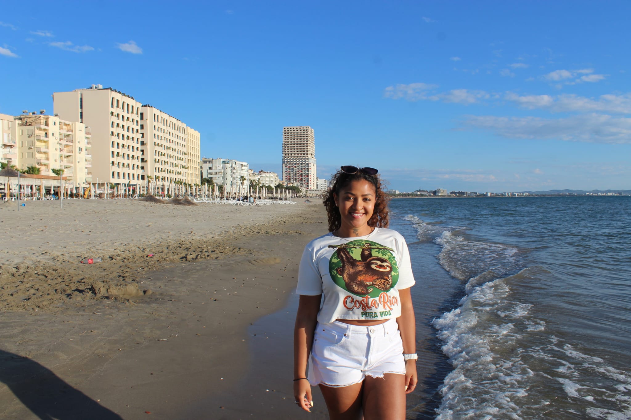<p>Aaliyah, pictured on the beach in Albania, has now been to nine she has visited with friends made on Bumble</p>