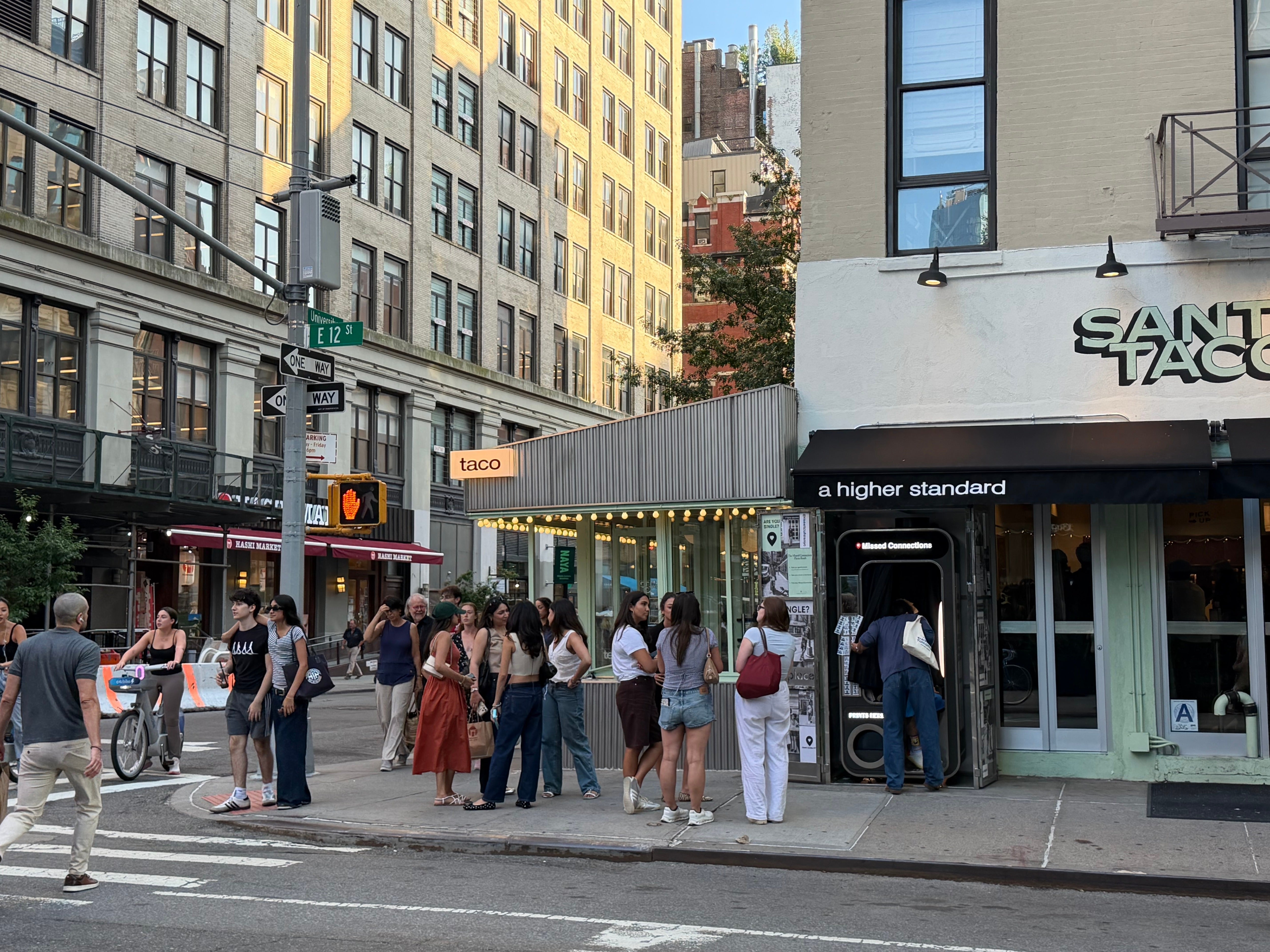 Hopeful singles wait in line for the ‘Missed Connections’ photobooth on East 12th Street and University Place in Manhattan