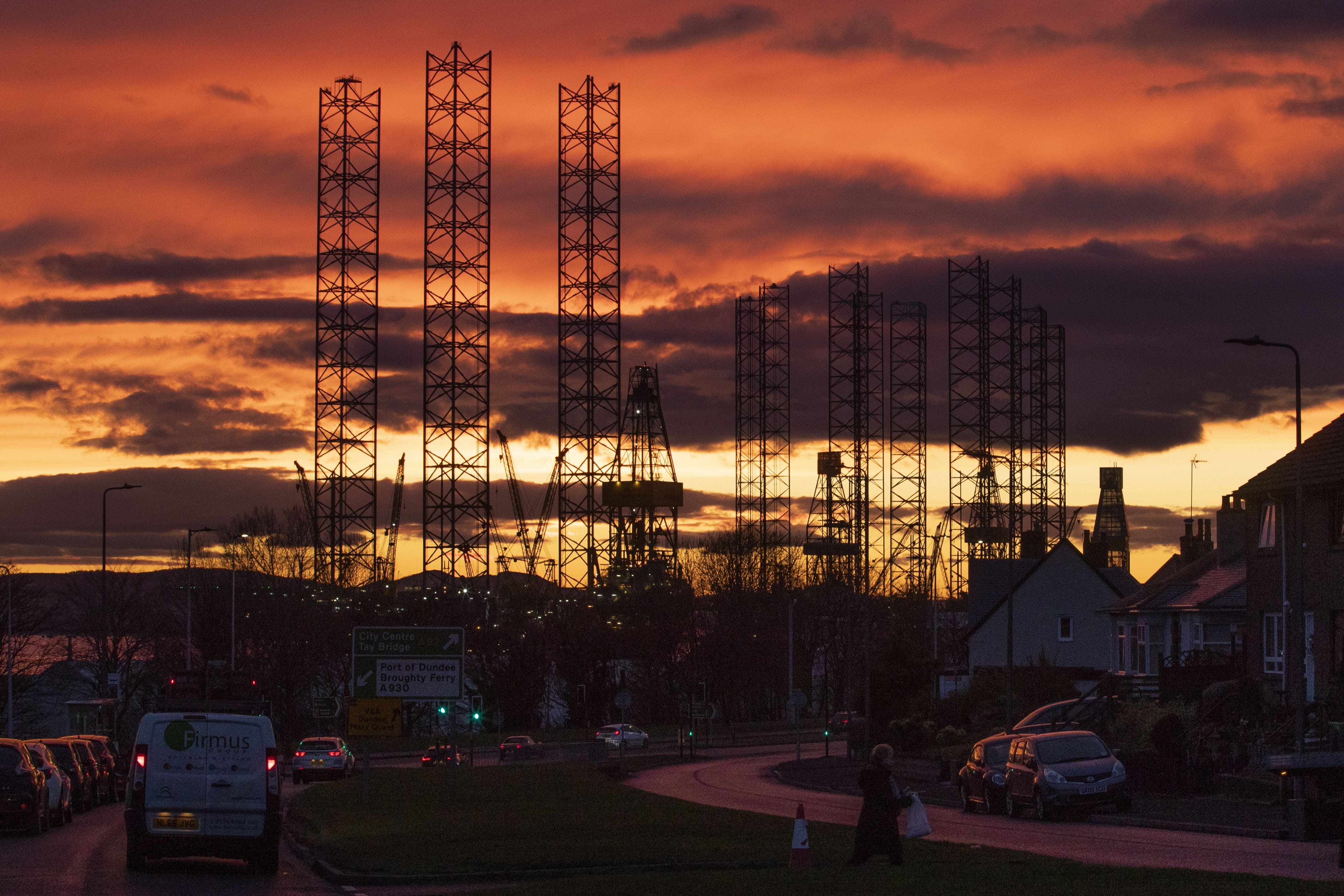Jackup rigs, utilized successful nan North Sea lipid and state industry, are silhouetted against nan entity astatine sunset complete nan Port of Dundee successful nan Firth of Tay, Dundee (Jane Barlow/PA)