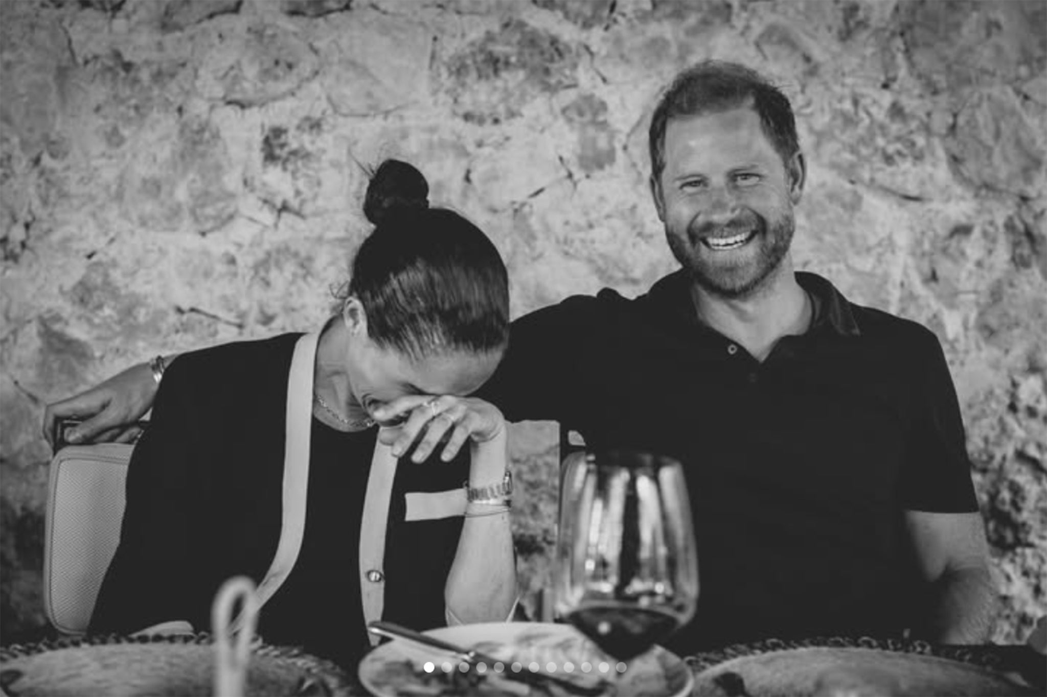 The Duke and Duchess of Sussex smile and laugh at dinner