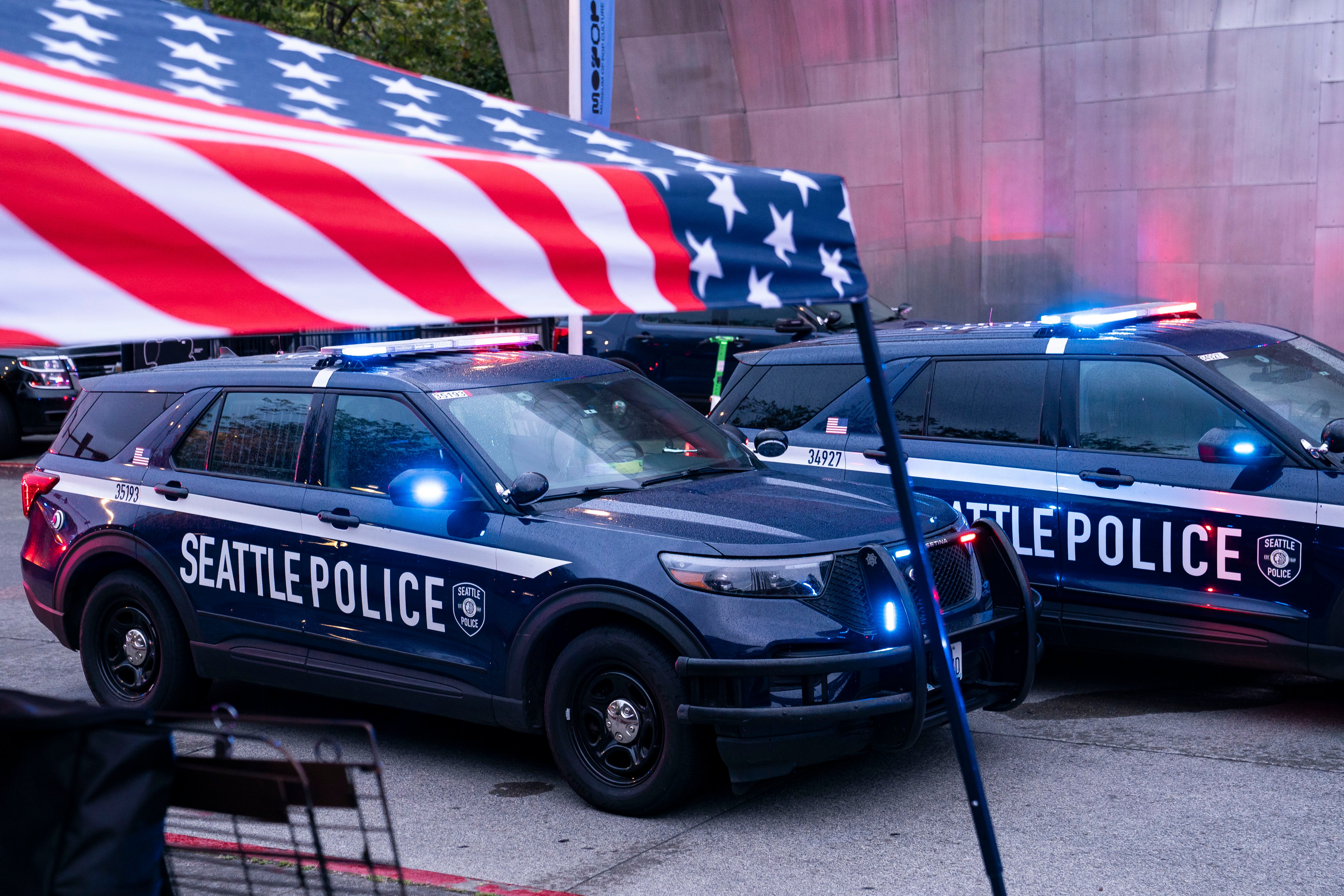 Police vehicles are parked adjacent to a vendor shelter pursuing a wide shooting astatine nan Bite of Seattle nutrient show connected 26 July 2026 successful Seattle, Washington