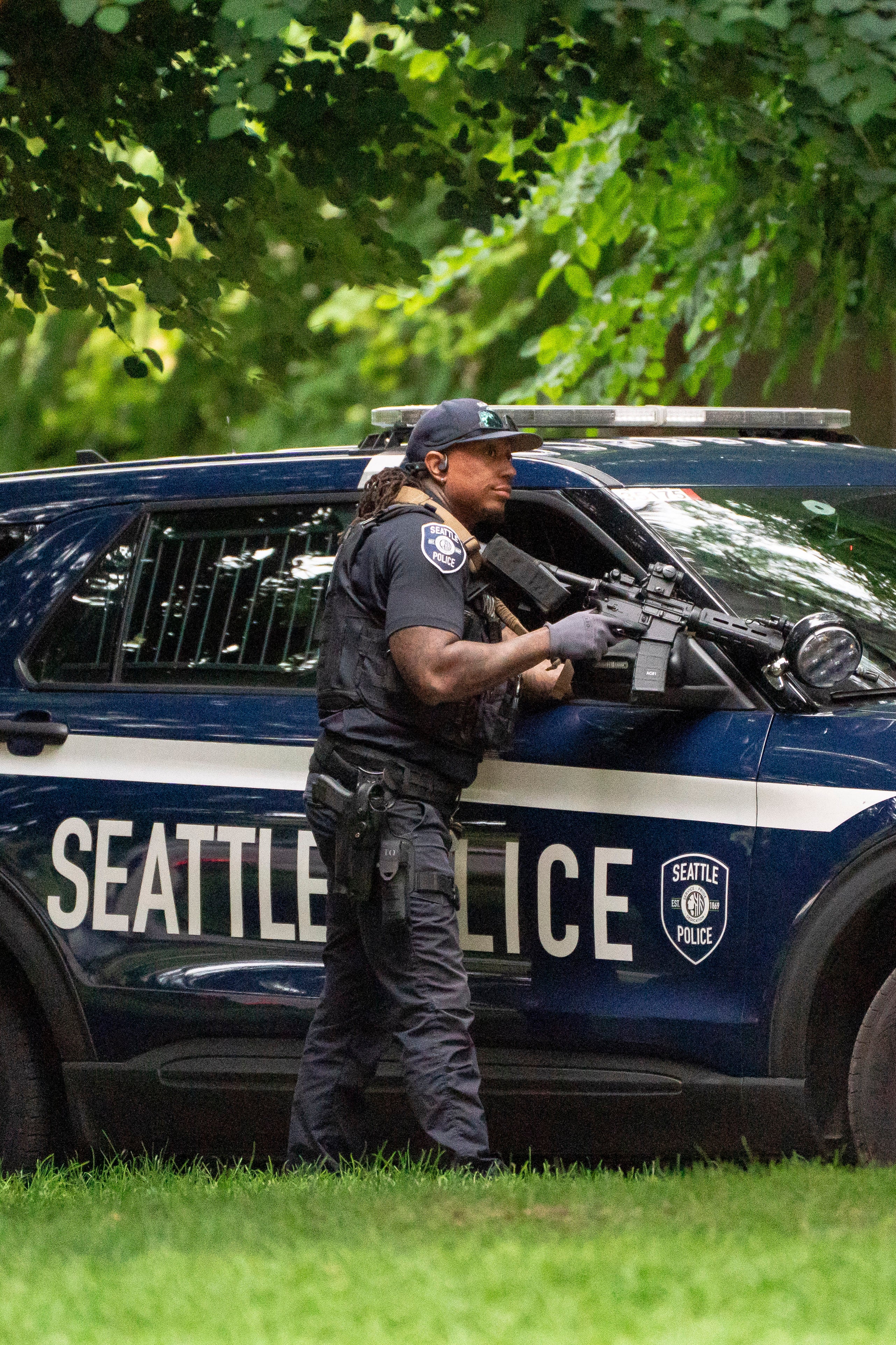 A constabulary serviceman holds a limb down a constabulary conveyance aft a wide shooting astatine nan Bite of Seattle nutrient show connected 26 July 2026 successful Seattle, Washington