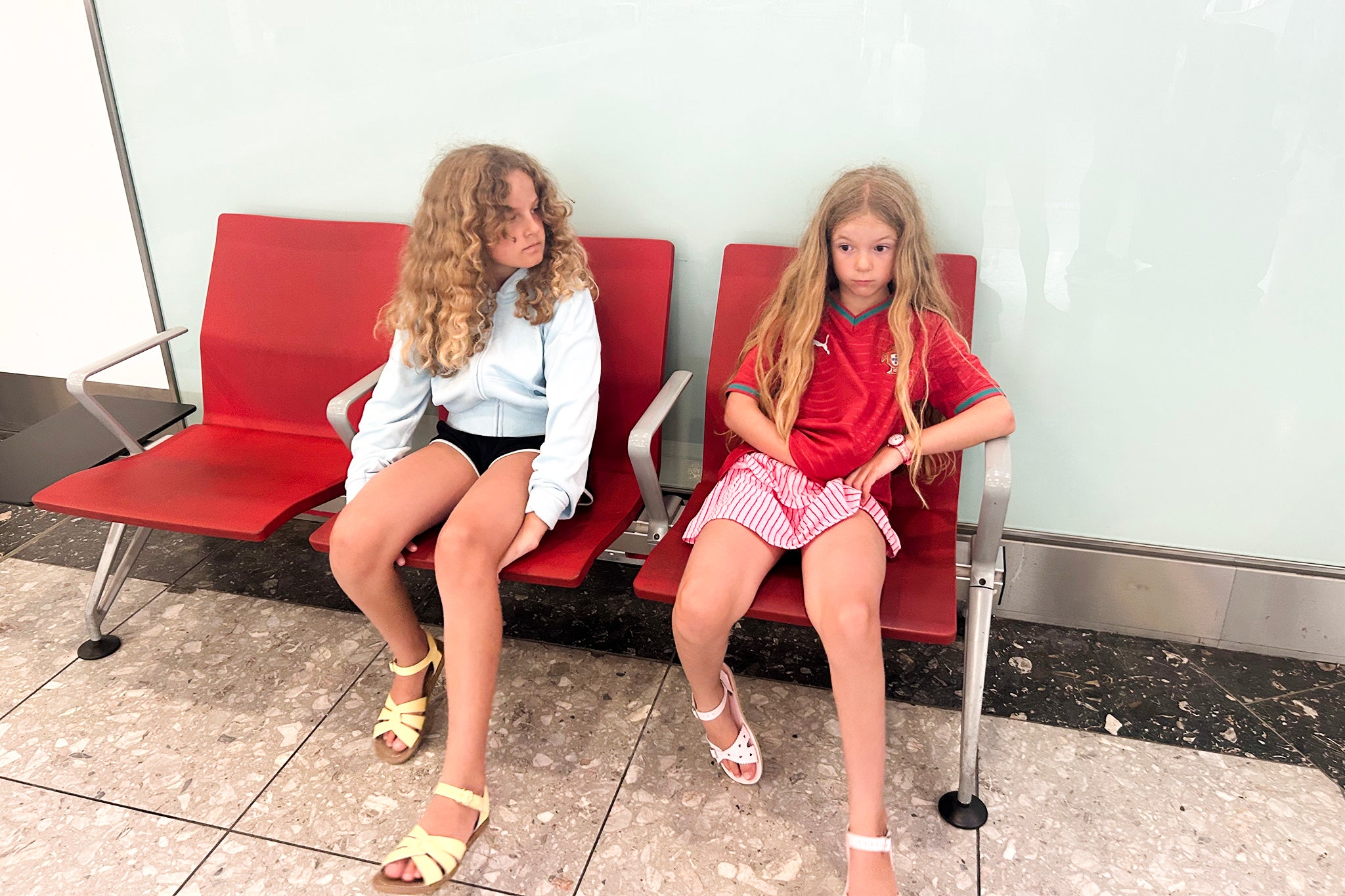 Charlotte’s daughters, Lola, 10, and Liberty, eight, are bored at the airport this summer