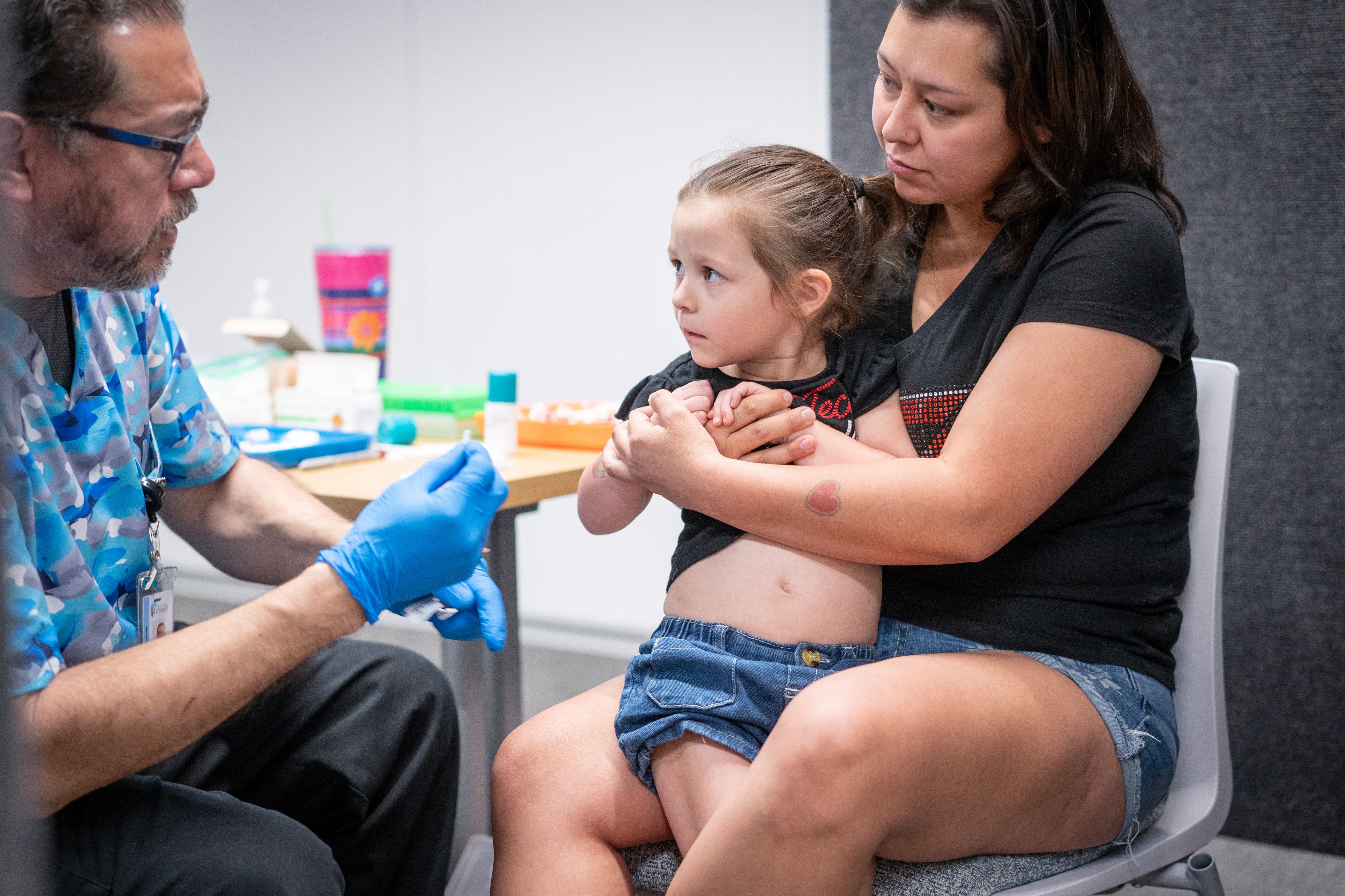 A female holds her young girl while she gets nan MMR vaccine astatine a session successful Lubbock, Texas, past year. Kennedy said parents  should springiness their children nan shots connected CNN this weekend
