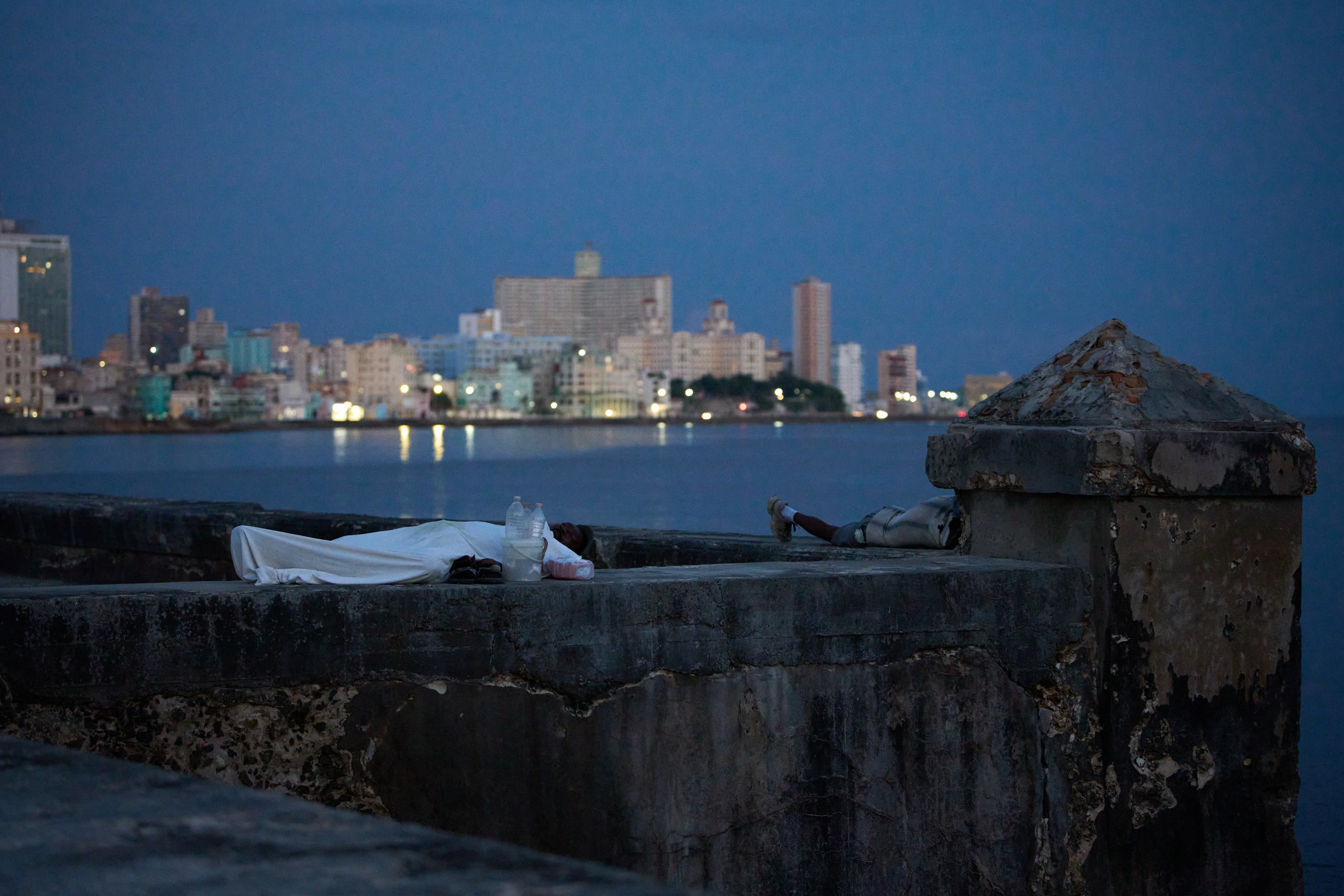 People sleep on the Malecón seawall to escape the heat of their homes during a power outage in Havana, Cuba, Wednesday, Aug. 5, 2026