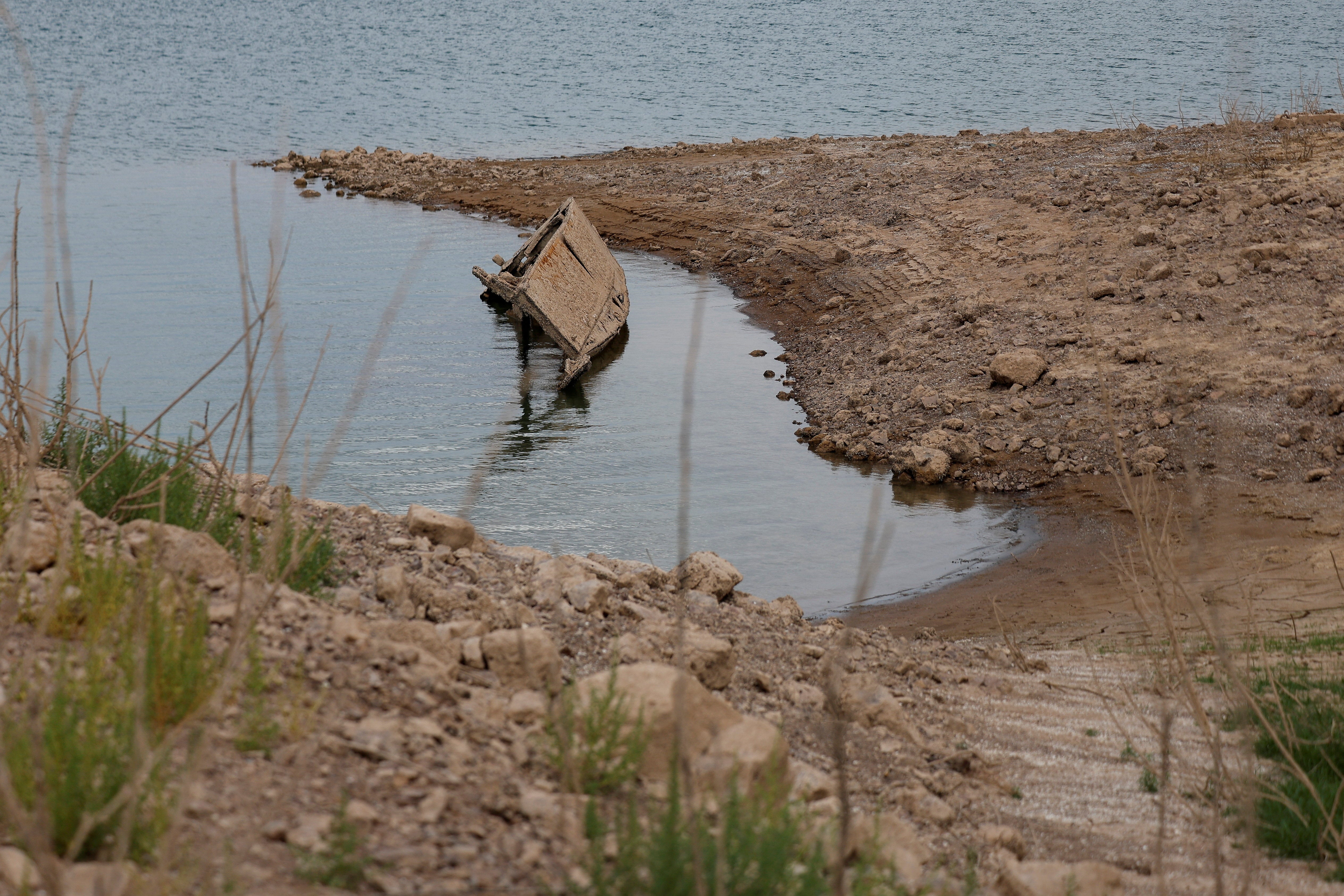 As h2o levels drop, nan receding h2o exposes hidden shorelines, aged rocks, onshore and objects that stayed underwater for decades