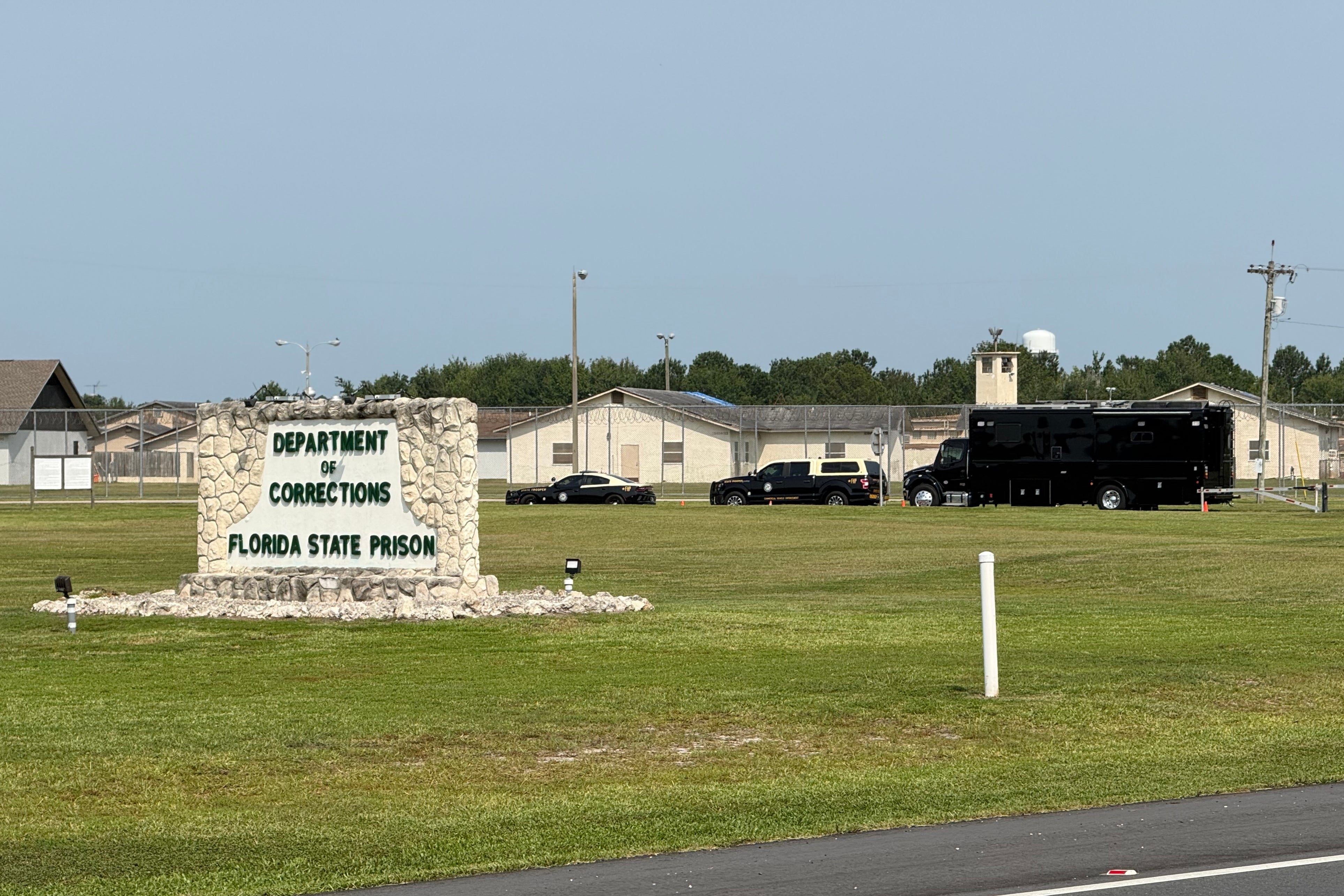 Law enforcement vehicles sit parked outside the Florida state prison in Starke, Fla., on Tuesday, July 28, 2026. (AP Photo/David Fischer, file)