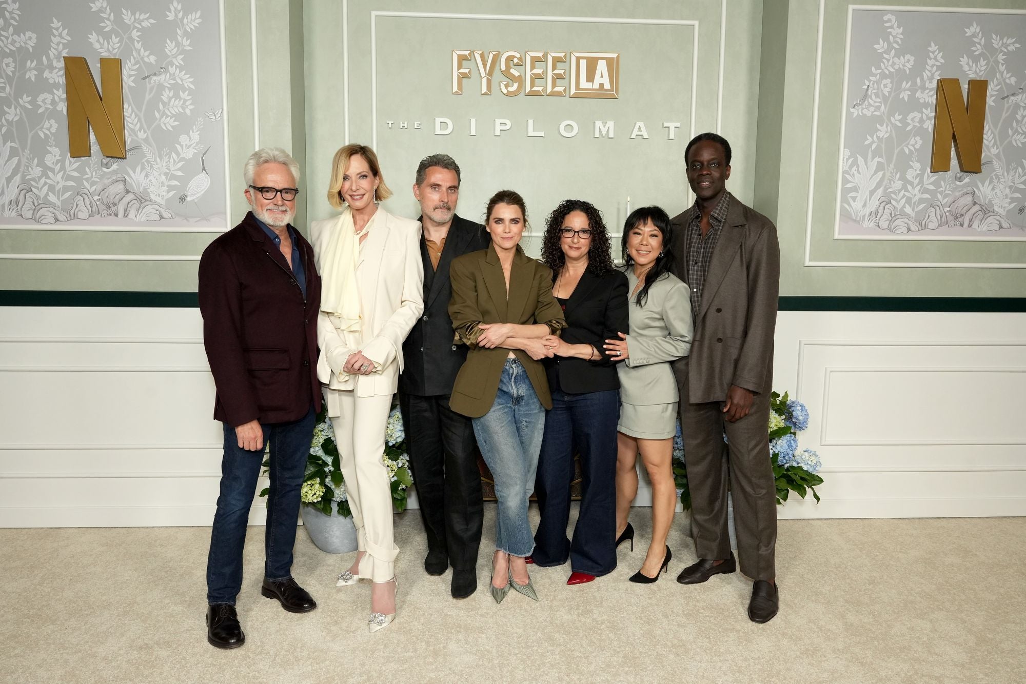 Janney (second from the left) is often taller than even her male co-stars