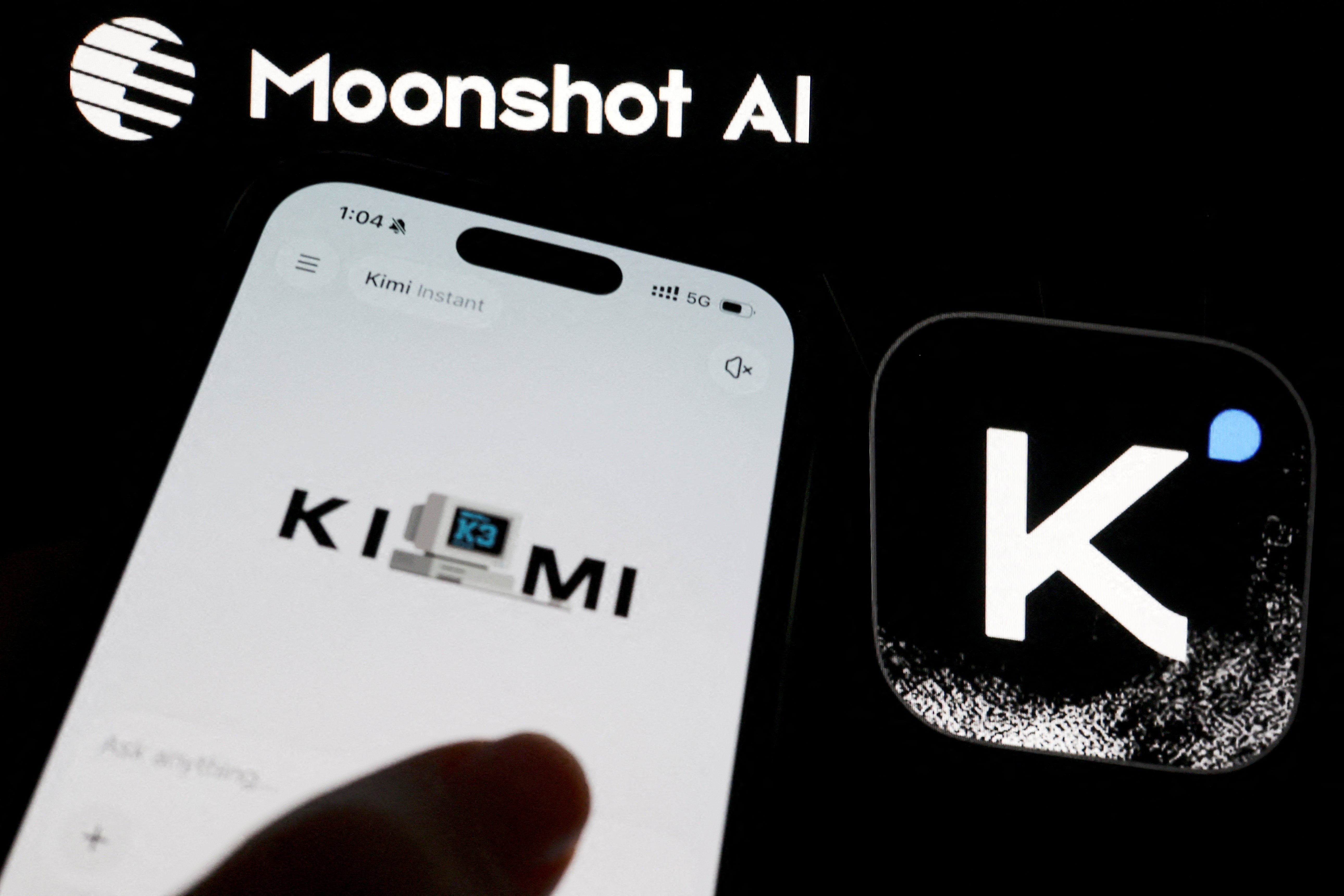 The logo of Chinese company Moonshot AI is displayed alongside its Kimi app on a mobile phone