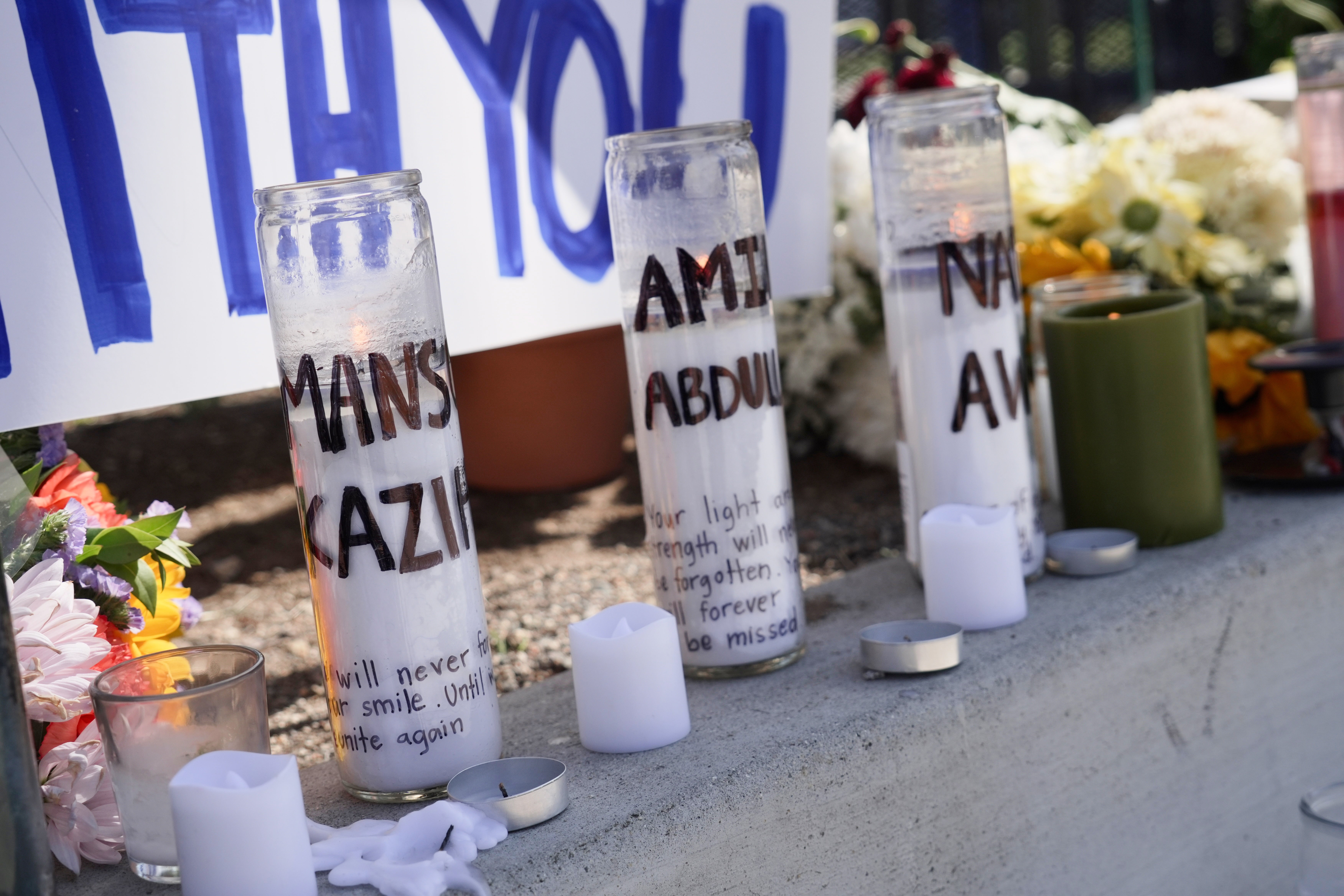 Candles with victim's names written on them outside the Islamic Center of San Diego, in the aftermath of a shooting