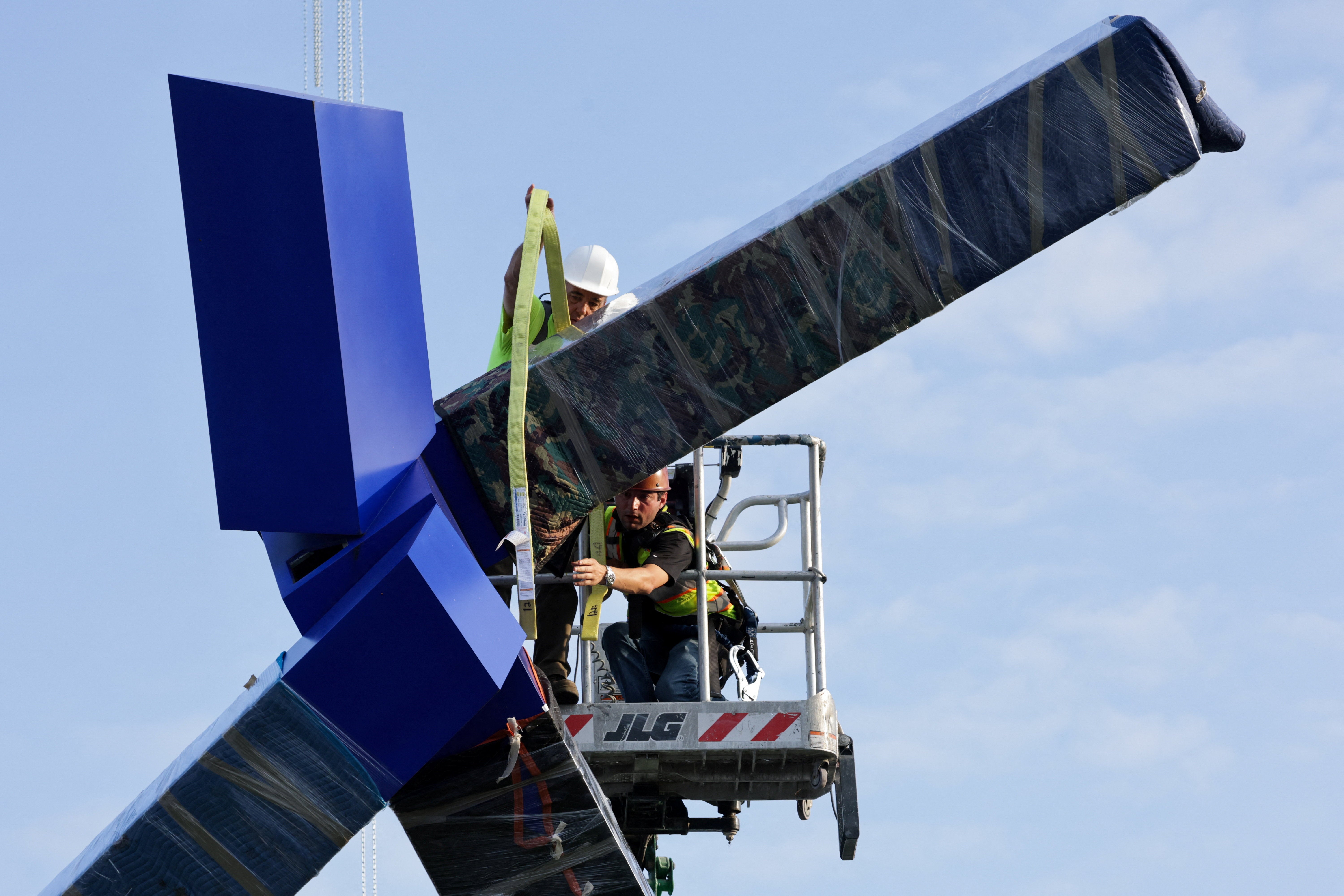 Workers abruptly began removing Joel Shapiro’s beloved ‘Blue’ sculpture from the Kennedy Center grounds on September 2 as the venue’s Donald Trump-dominated board seeks to renovate the site in the president’s image (Reuters)