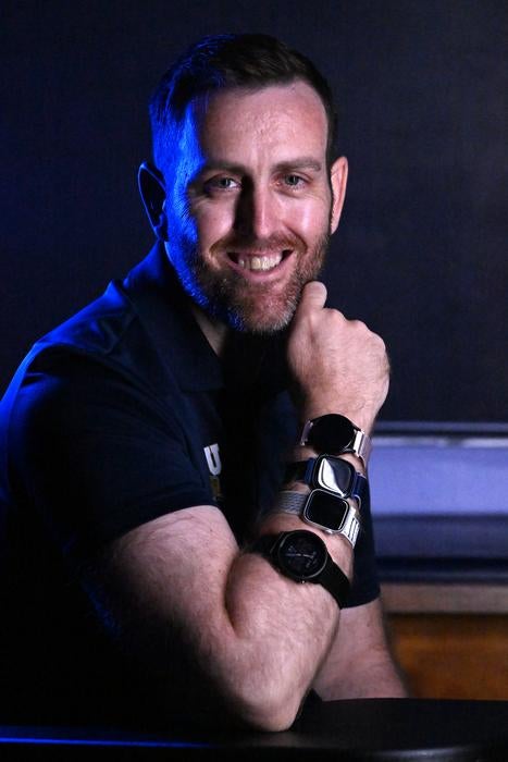 FIU researcher Jason Kostrna, wears the four smartwatches tested in his study. The watches include the Apple Watch Series 8, Fitbit Sense 2, Samsung Galaxy Watch 5 and Garmin Forerunner 955