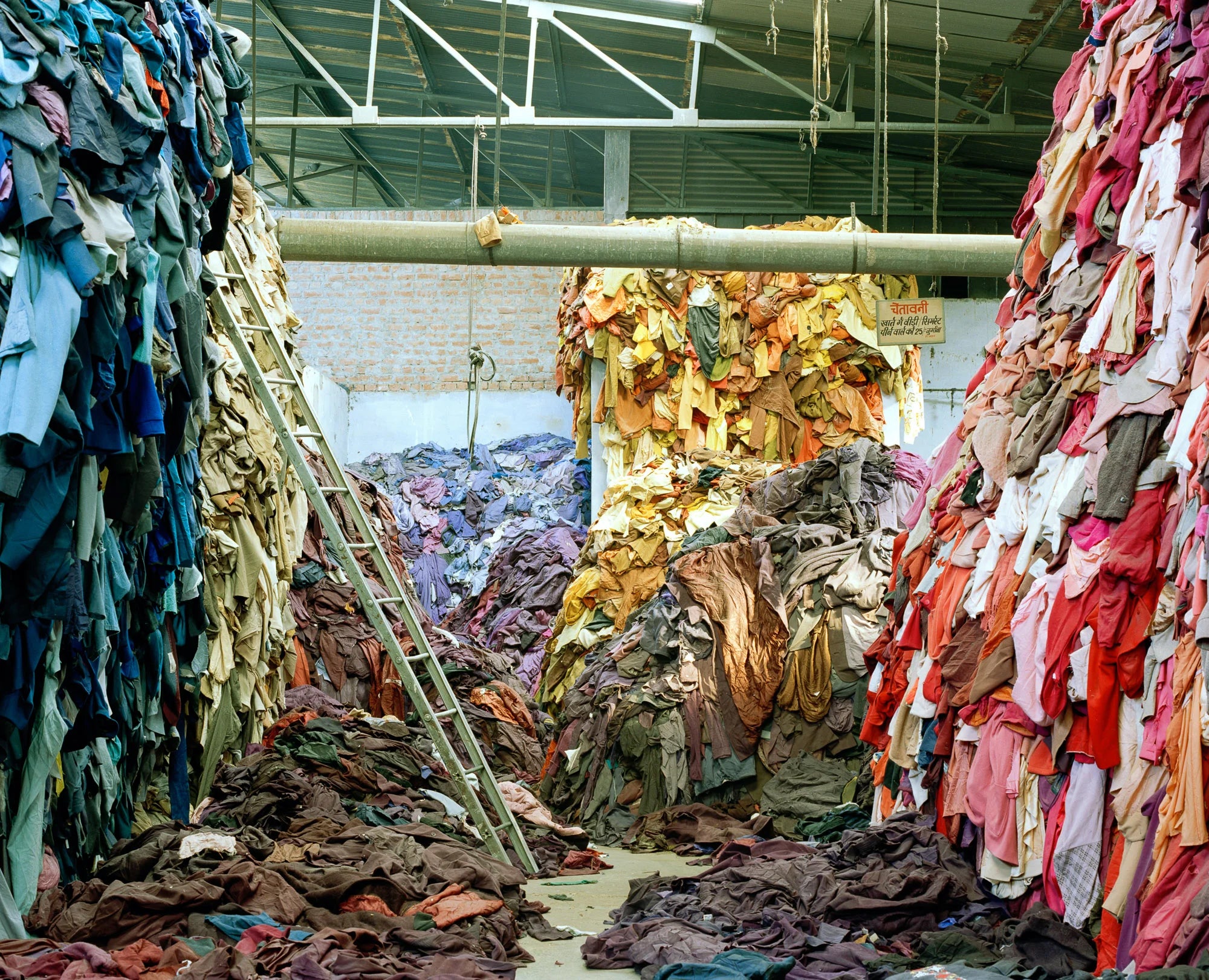 Mountains of discarded clothing expose the scale of fashion’s waste crisis, a challenge explored through repair, reuse and circularity at Craft, Clothing & Circularity: Out of Fashion on 11 September