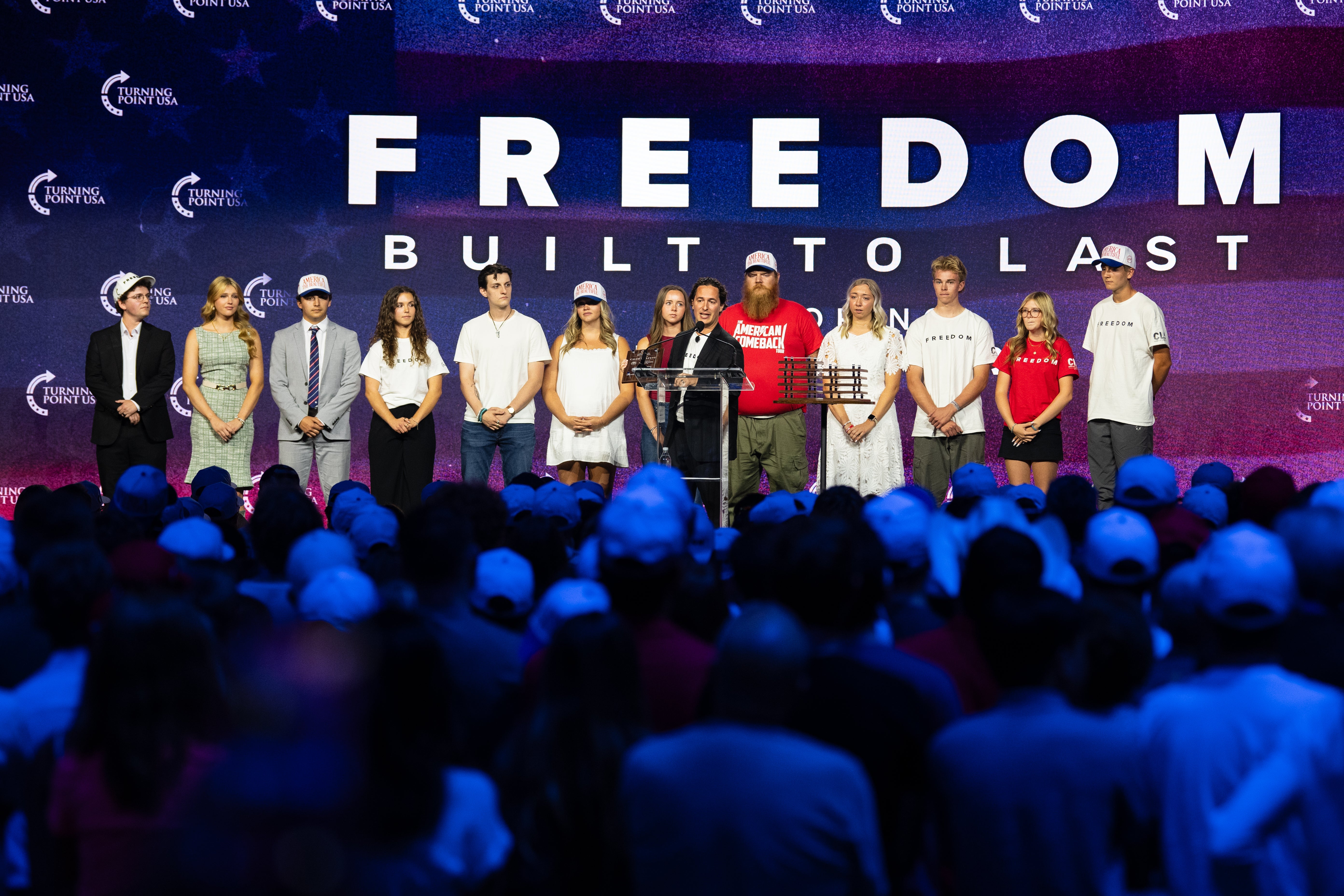 Individuals who were present at the scene of Turning Point USA founder Charlie Kirk's fatal shooting stand together on stage during a Charlie Kirk memorial service at the UCCU Center on September 10, 2026 in Orem