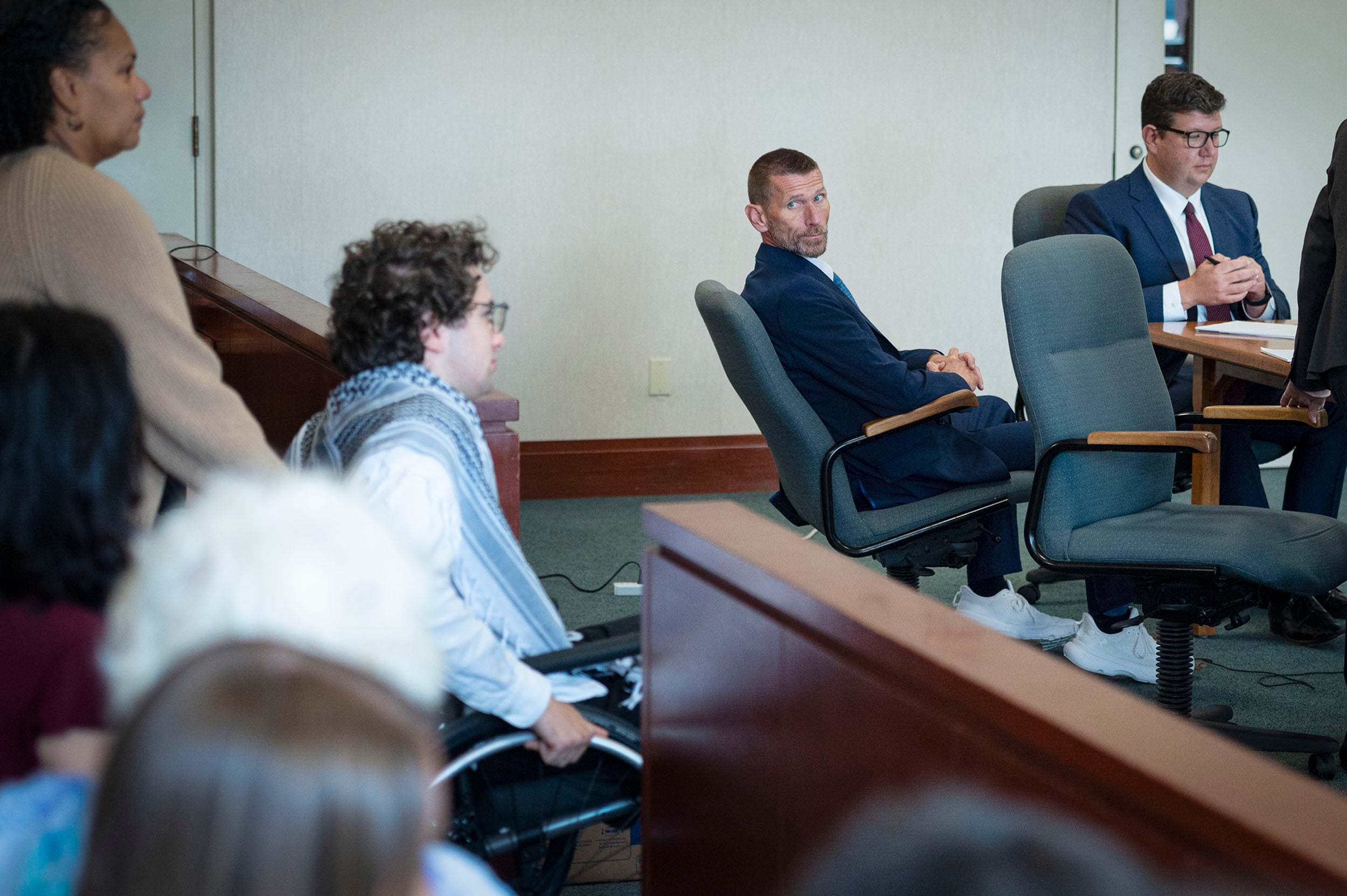 Jason Eaton watches as Hisham Awartani arrives to testify in Eaton's trial in Burlington
