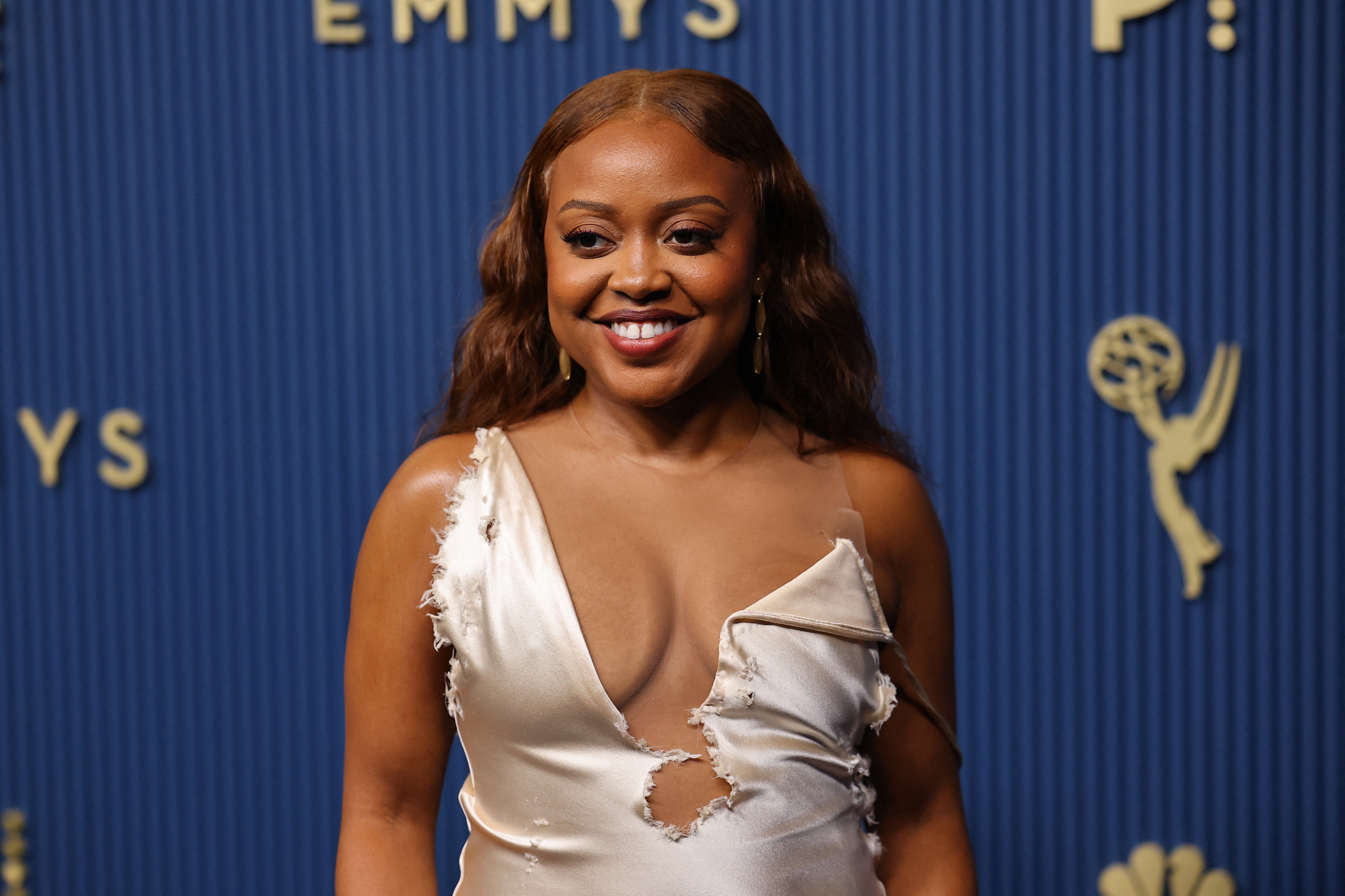 'Abbott Elementary' star Quinta Brunson's gown was ... intentionally messy? It looked like it had fallen victim to a dog at playtime with its ripped seams and stitches