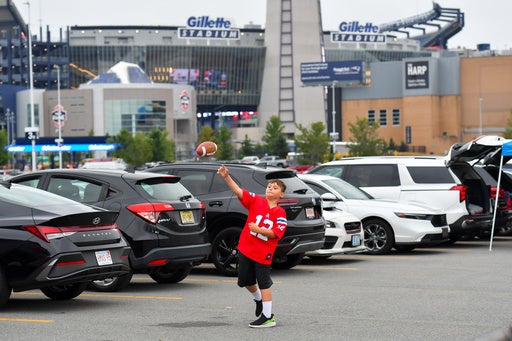 Lucas Teixeira, 8, throws a football outside Gillette Stadium prior to an NFL preseason football game against the Philadelphia Eagles