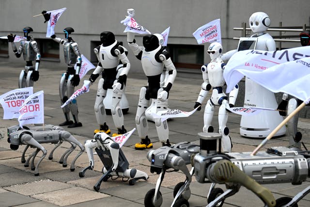 Humanoid and quadruped robots during a demonstration calling for the regulation of artificial intelligence development