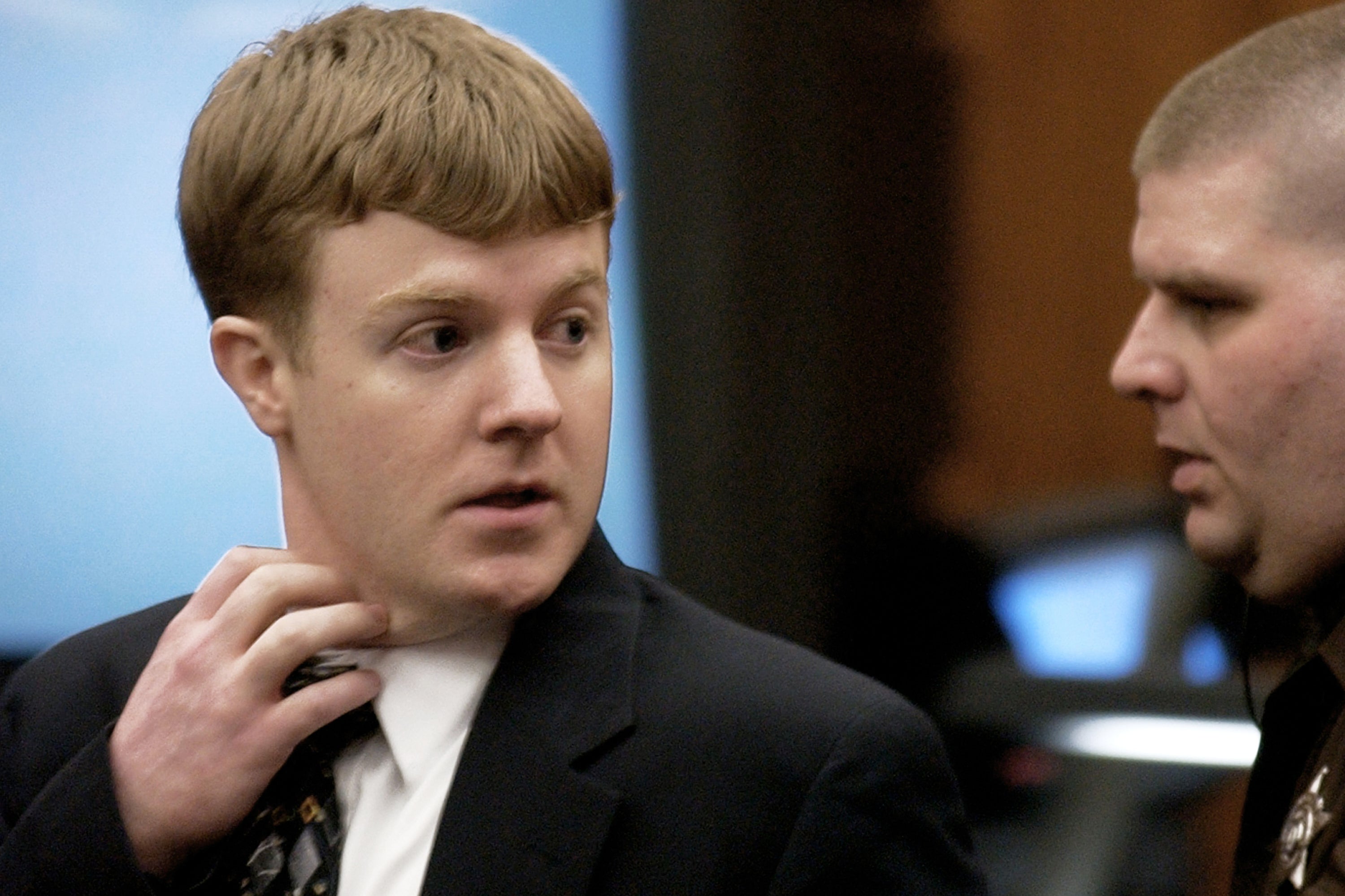 Wolfe, left, looks back towards his parents as he is led from the courtroom by a sheriff's deputy after being found guilty of capital murder in Manassas, Va., Jan. 22, 2002